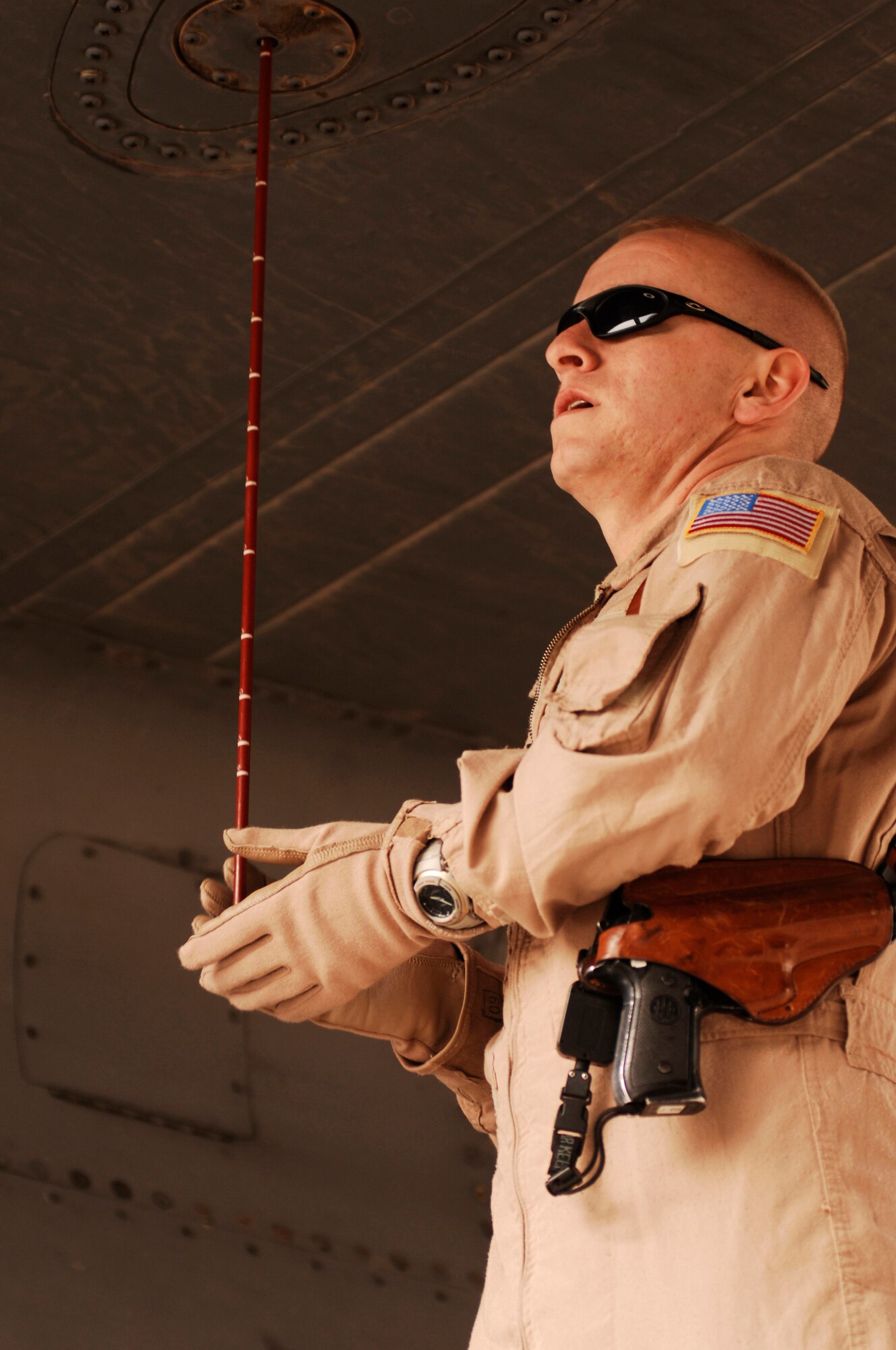 SOUTHWEST ASIA -- Staff Sgt. Daniel Brewer, a C-130 Hercules flight engineer deployed with the 737th Expeditionary Airlift Squadron, verifies the level of fuel inside of a C-130 fuel tank at an air base in the Persian Gulf Region Feb. 16, 2008. A part of his duties include a preflight inspection of the aircraft before takeoff. Sergeant Brewer is deployed from Yokota Air Base, Japan in support of Operations Enduring and Iraqi Freedom. (U.S. Air Force photo/ Staff Sgt. Patrick Dixon)