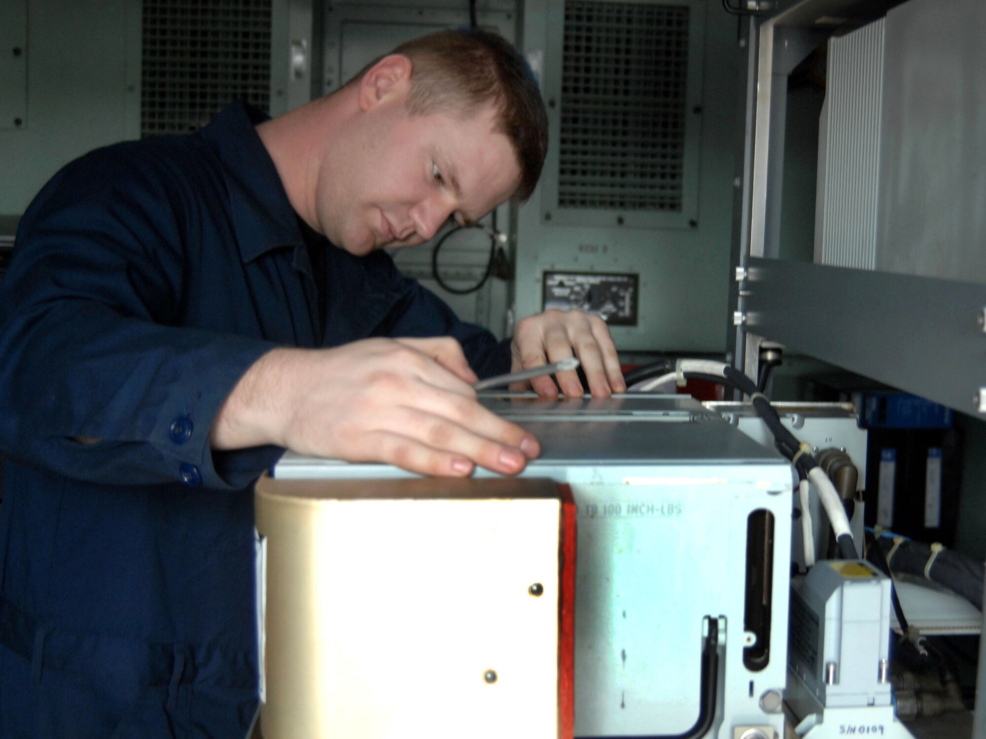 Senior Airman Kyle Waddle inspects a multiplexor box that combines signals that go back and forth from the ground to aircraft.  The digital systems technician deployed here last week with the 603rd Air Control Squadron from Aviano Air Base, Italy, in support of the President George W. Bush's five-nation visit to Africa.
