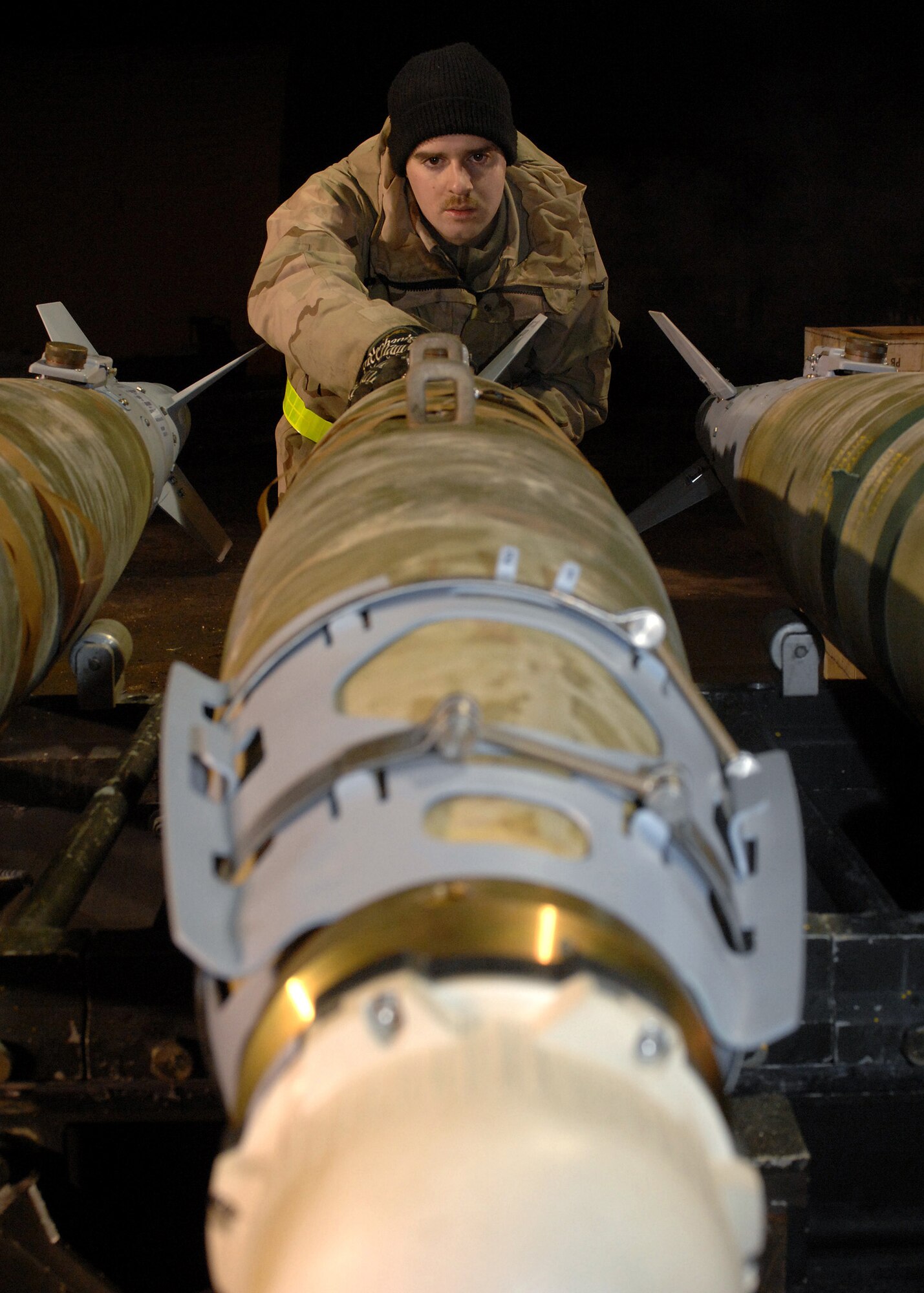 BAGRAM AIR BASE, Afghanistan - Airman 1st Class Ryan Thompson, 455th Expeditionary Maintenance Squadron, aligns strakes with lugs on a GBU-38 bomb here Feb 14. Members from AMMO assembled 24 bombs in a 2-hour time frame. Thompson's home unit is the 52nd Equipment Maintenance Squadron, Spangdahlem Air Base, Germany. (U.S. Air Force photo by Master Sgt Demetrius Lester)