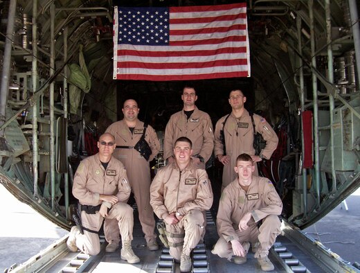 SOUTHWEST ASIA -- A 737th Expeditionary Airlift Squadron crew out of Pope Air Force Base, N.C. flew a medevac mission Jan. 31, 2008 in support of Operation Iraqi Freedom which helped save the life of a 13-month-old Iraqi boy injured by an improvised explosive device attack in southern Iraq which claimed the lives of both his parents. The aircrew, (top row left to right) Capt. Jeff Noble, aircraft commander, Capt. Neil Hoy, co-pilot, Capt. Nathan Preuss, navigator, and (bottom row left to right) Senior Master Sgt. J.R. Miller, engineer, Senior Airman Chase Cantrell and Airman 1st Class Ross Hagen, loadmasters, recently returned home from their deployment to a Southwest Asia air base in support of the Global War on Terror. Their mission while deployed was to transport cargo and passengers throughout the deployed theater. (Courtesy photo)