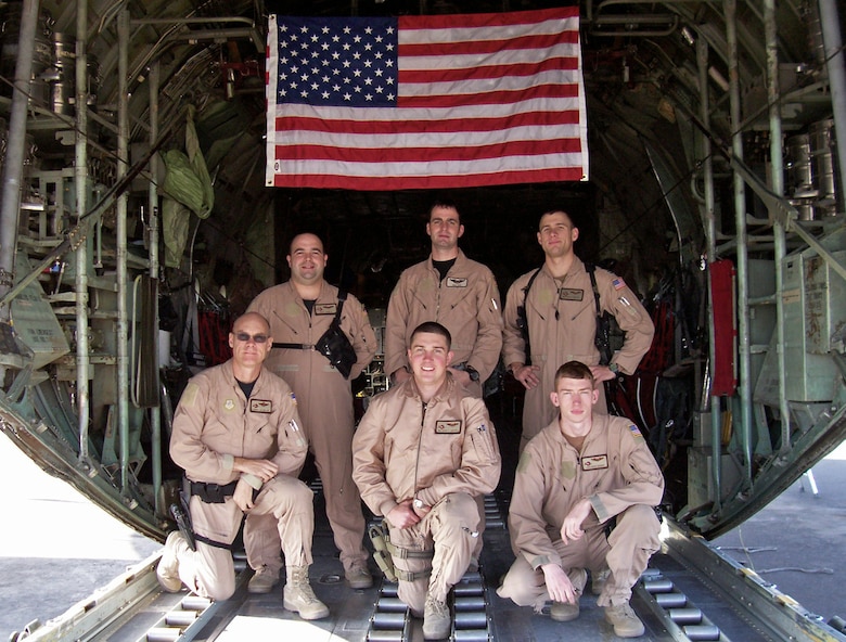 SOUTHWEST ASIA -- A 737th Expeditionary Airlift Squadron crew out of Pope Air Force Base, N.C. flew a medevac mission Jan. 31, 2008 in support of Operation Iraqi Freedom which helped save the life of a 13-month-old Iraqi boy injured by an improvised explosive device attack in southern Iraq which claimed the lives of both his parents. The aircrew, (top row left to right) Capt. Jeff Noble, aircraft commander, Capt. Neil Hoy, co-pilot, Capt. Nathan Preuss, navigator, and (bottom row left to right) Senior Master Sgt. J.R. Miller, engineer, Senior Airman Chase Cantrell and Airman 1st Class Ross Hagen, loadmasters, recently returned home from their deployment to a Southwest Asia air base in support of the Global War on Terror. Their mission while deployed was to transport cargo and passengers throughout the deployed theater. (Courtesy photo)