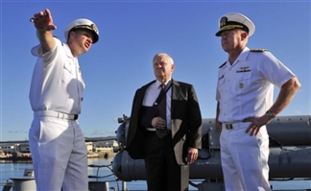 Defense Secretary Robert M. Gates, center, talks with Navy Cmdr. Jeffrey Weston, left, commanding officer of the USS Russell, and Adm. Robert Willard, right, commander of the U.S. Pacific Fleet, aboard the ship in Pearl Harbor, Hawaii, on Thursday, Feb. 21, 2008.  