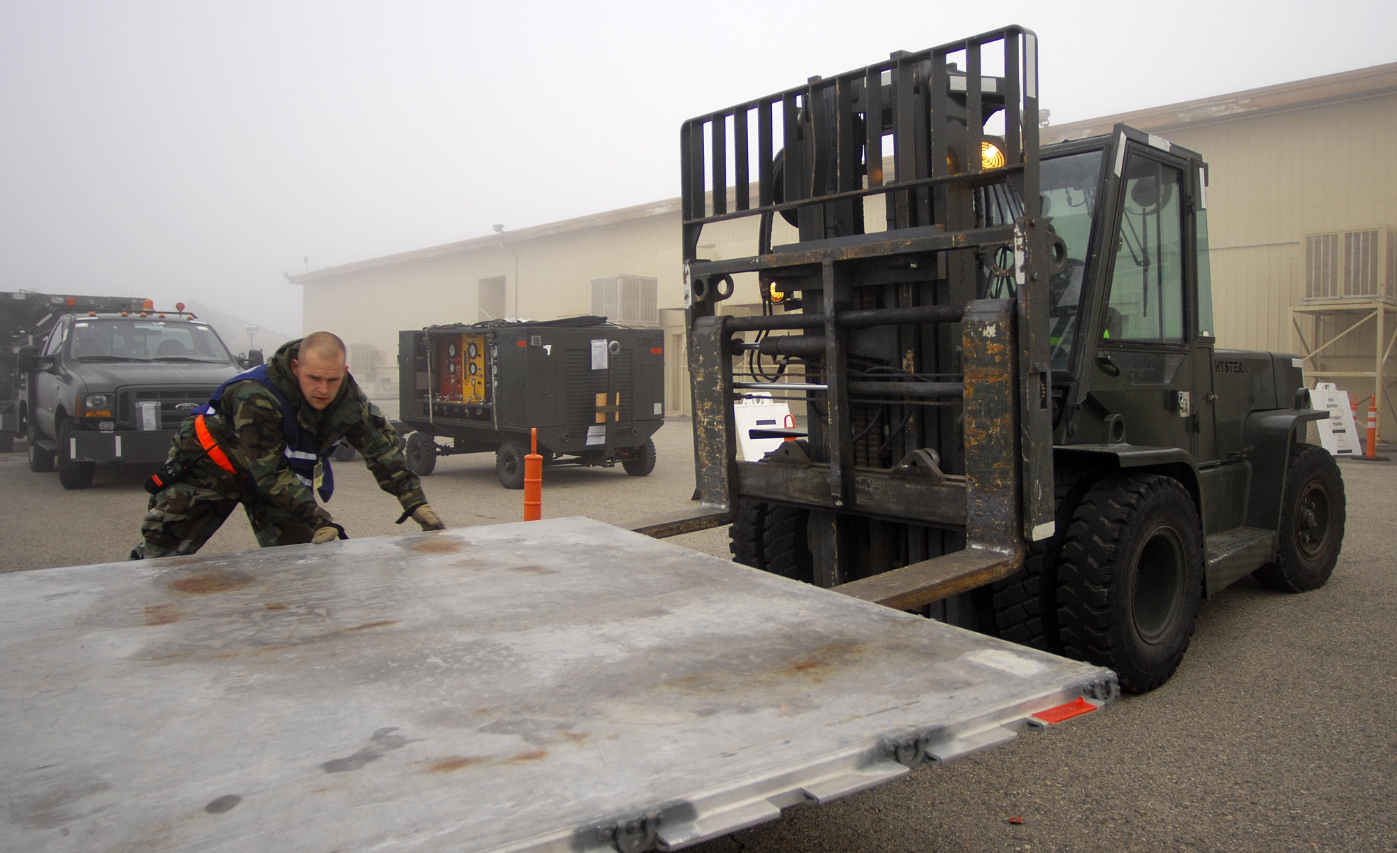 MOUNTAIN HOME AIR FORCE BASE, Idaho – Tech. Sgt. Stuart Link, 366th Logistics Readiness Squadron cargo deployment function in-check technician, assists Staff Sgt. Rachel Warren, 366th Logistics Readiness Squadron vehicle operator, with loading pallets onto the forklift during Exercise Sharpshooter 08-04 Feb. 23. The CDF is responsible for measuring, weighing and taking accountability for all the cargo on base that will be processed for deployment.  The 366th Fighter Wing conducts exercises to prepare personnel and equipment for the upcoming March 2008 Operational Readiness Inspection. (U.S. Air Force photo/ Airman 1st Class Ryan Crane)