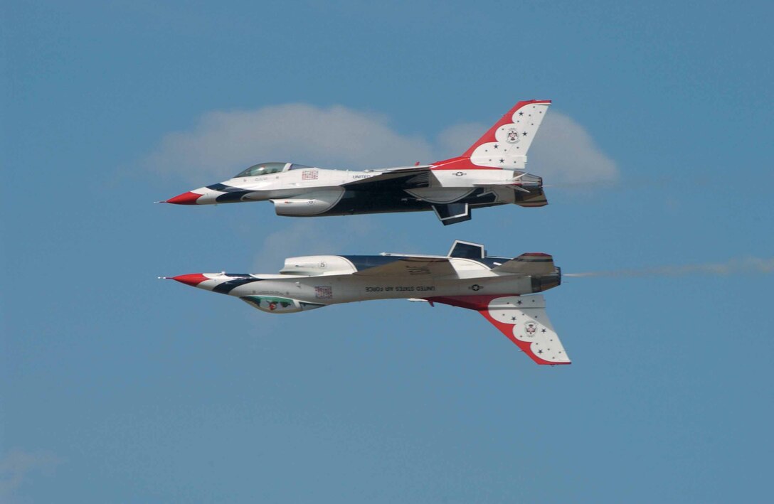 Spectators may find it hard to tell which way is up when watching the U.S. Air Force Thunderbird aerial demonstration team perform precision maneuvers such as this solo and opposing solo jet maneuver.  The Thunderbirds head a spectacular lineup of aviation demonstrations and performances at this year's Star Spangled Salute.  In addition to aerial performances, the May 24 event will also feature a wide variety of exhibits, concessions and ground entertainment.  (Air Force photo)
