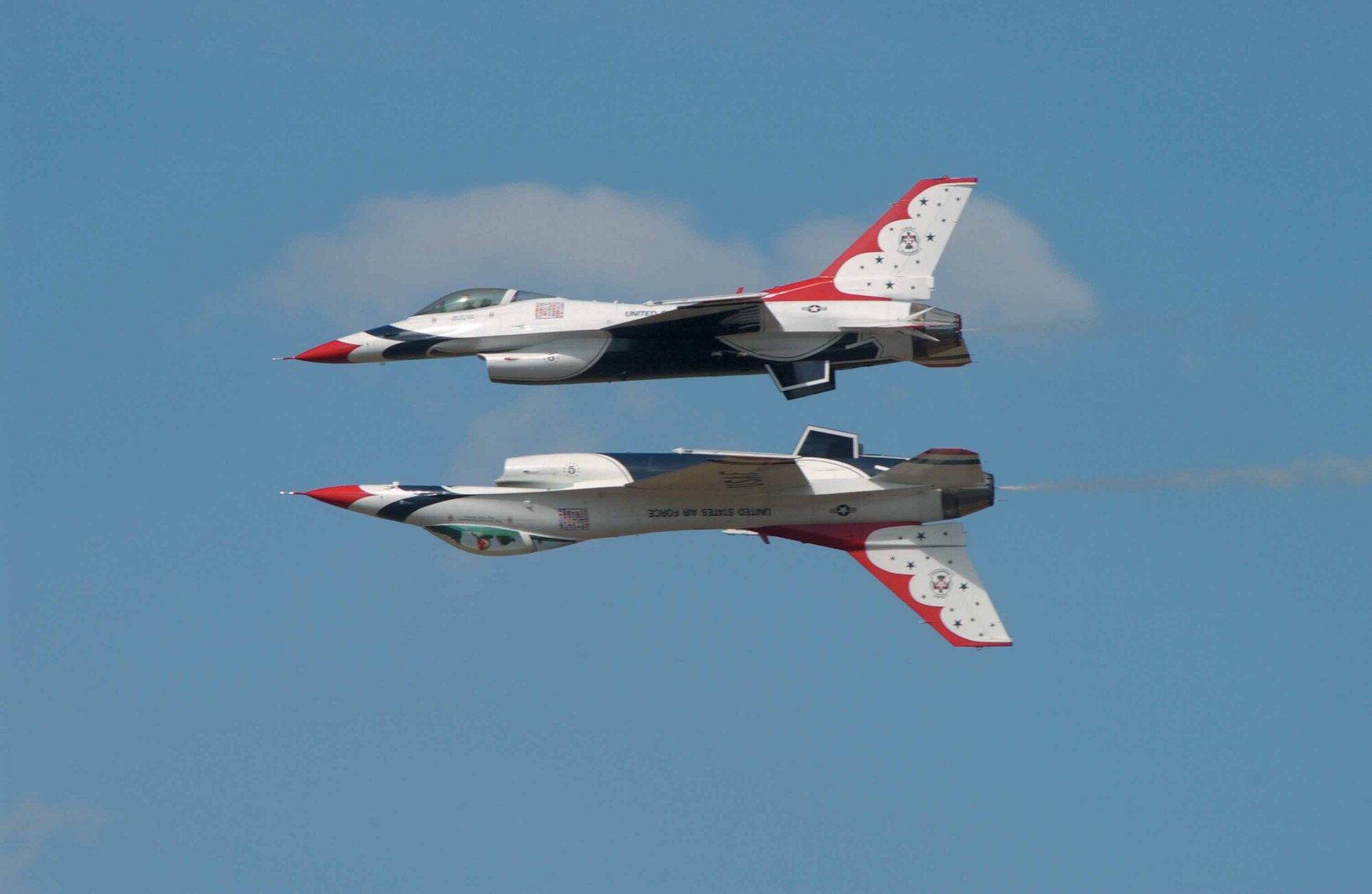 Spectators may find it hard to tell which way is up when watching the U.S. Air Force Thunderbird aerial demonstration team perform precision maneuvers such as this solo and opposing solo jet maneuver.  The Thunderbirds head a spectacular lineup of aviation demonstrations and performances at this year's Star Spangled Salute.  In addition to aerial performances, the May 24 event will also feature a wide variety of exhibits, concessions and ground entertainment.  (Air Force photo)