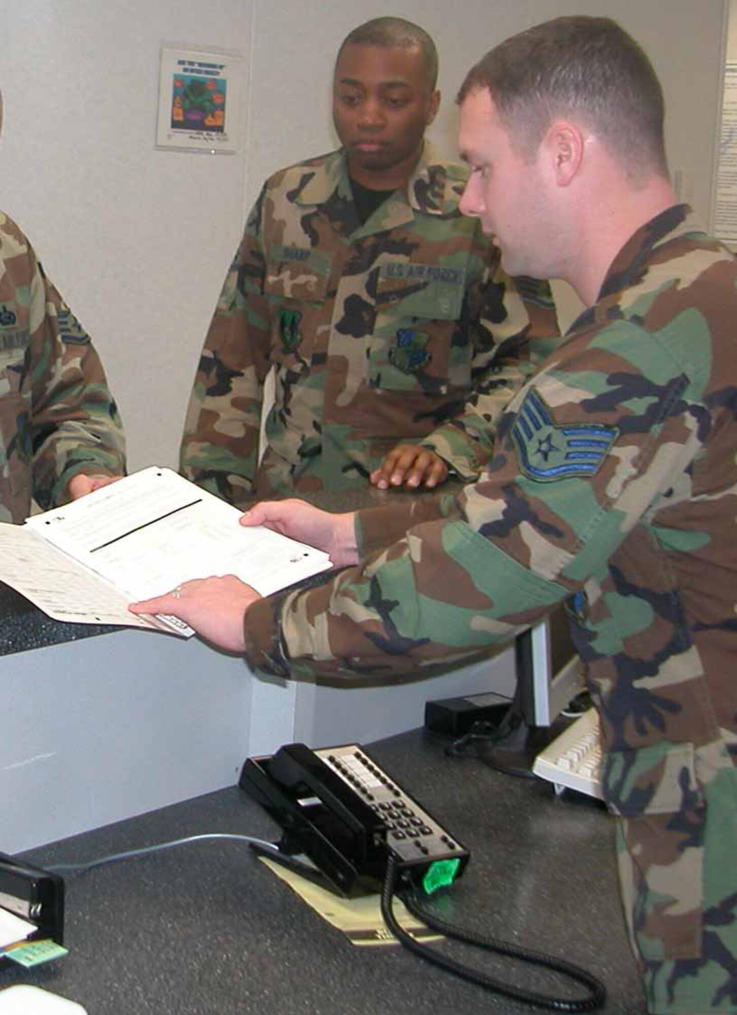 Staff Sgt. Jason Wilkins goes over a pre-deployment questionairre during a processing line.  (Courtesy photo)