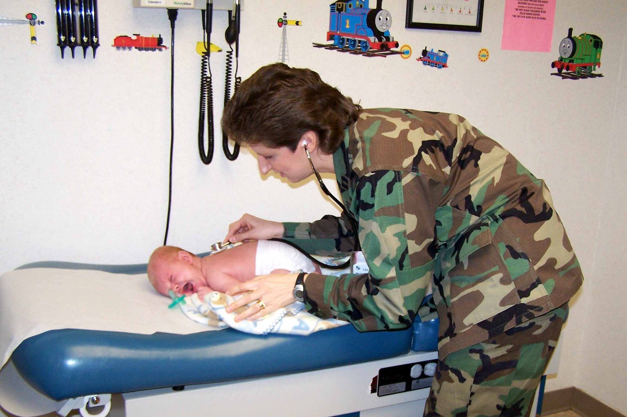 Capt. Margaret Linthicum gets vital signs on an infant during a well-baby visit.  (Courtesy photo)