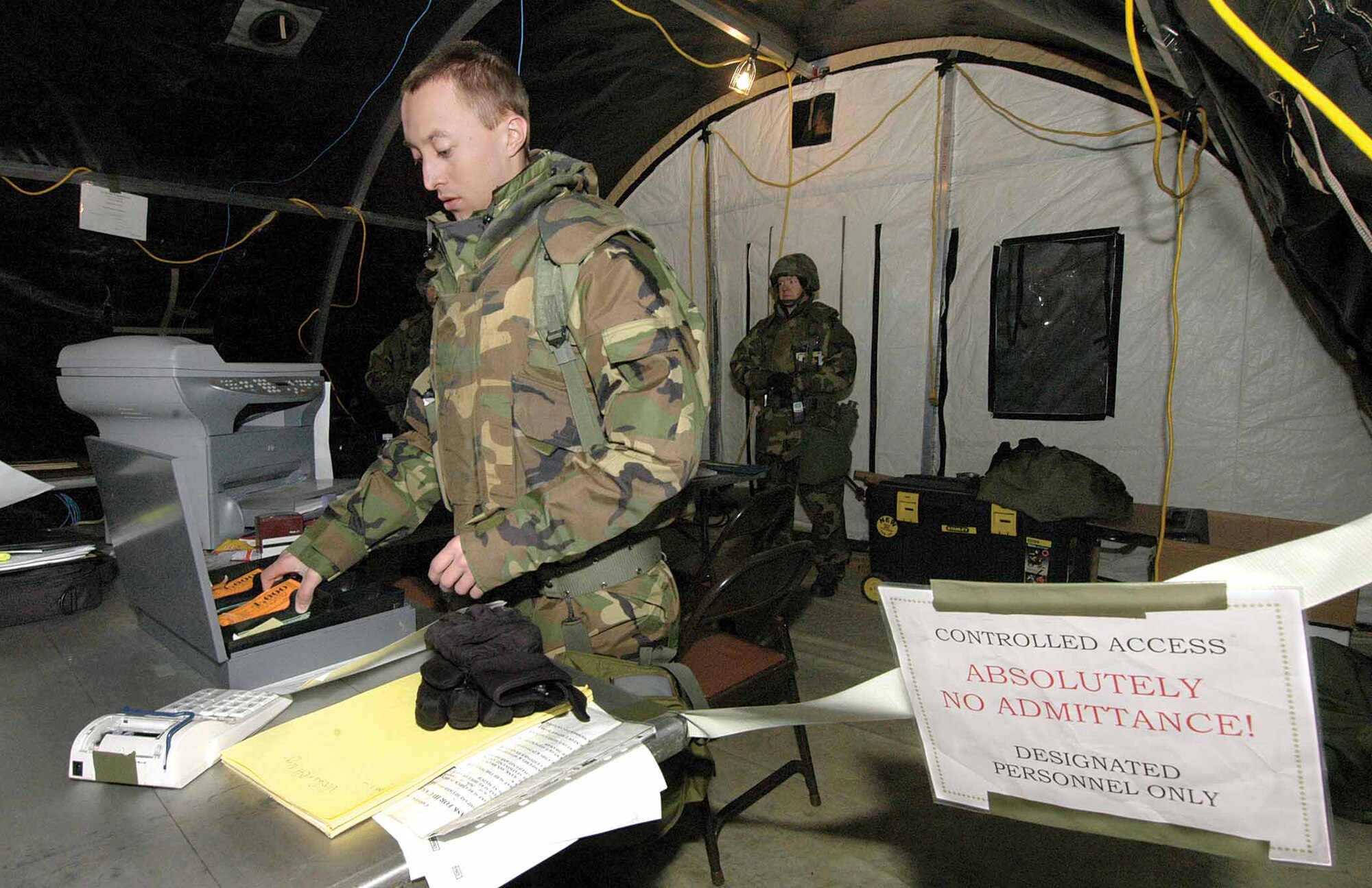 Airman 1st Class Micha Vickers, 72nd Comptrollers Squadron, prepares a cash advance on an Airman’s pay check during a Feb. 12 Resolute Warrior exercise scenario at the Glenwood Training Area.  (Air Force photo by Margo Wright)
