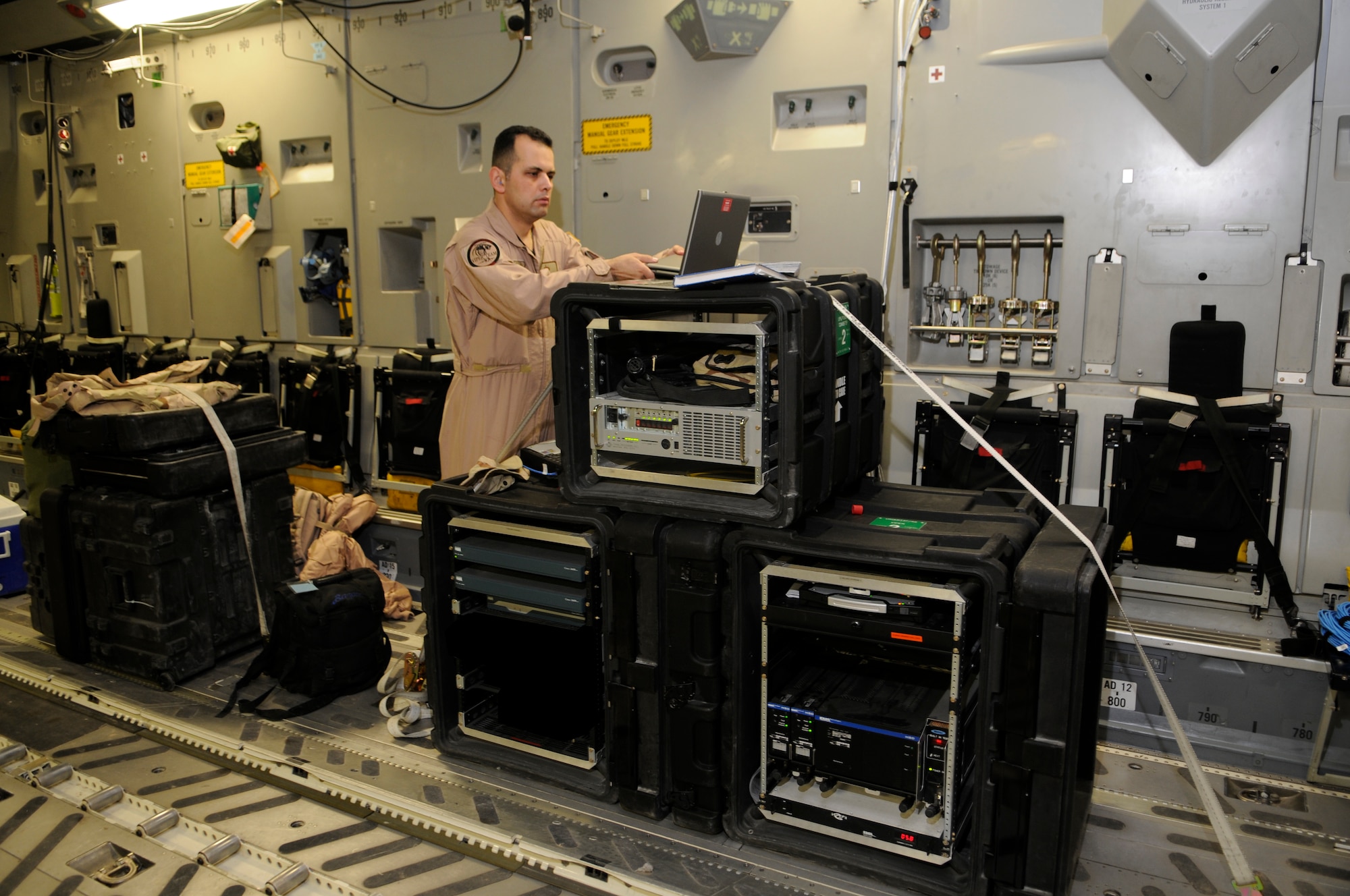Staff Sgt. Roland Bazan, 379th Expeditionary Communications Squadron, performs an operational check of the secure internet network at a Southwest Asia air base Feb 19. Sergeant Hagood ensures everything is operable before the C-17 takes off. He is deployed from Schriever Air Force Base, Colo.  (U.S. Air Force photo/Tech. Sgt. Johnny L. Saldivar)