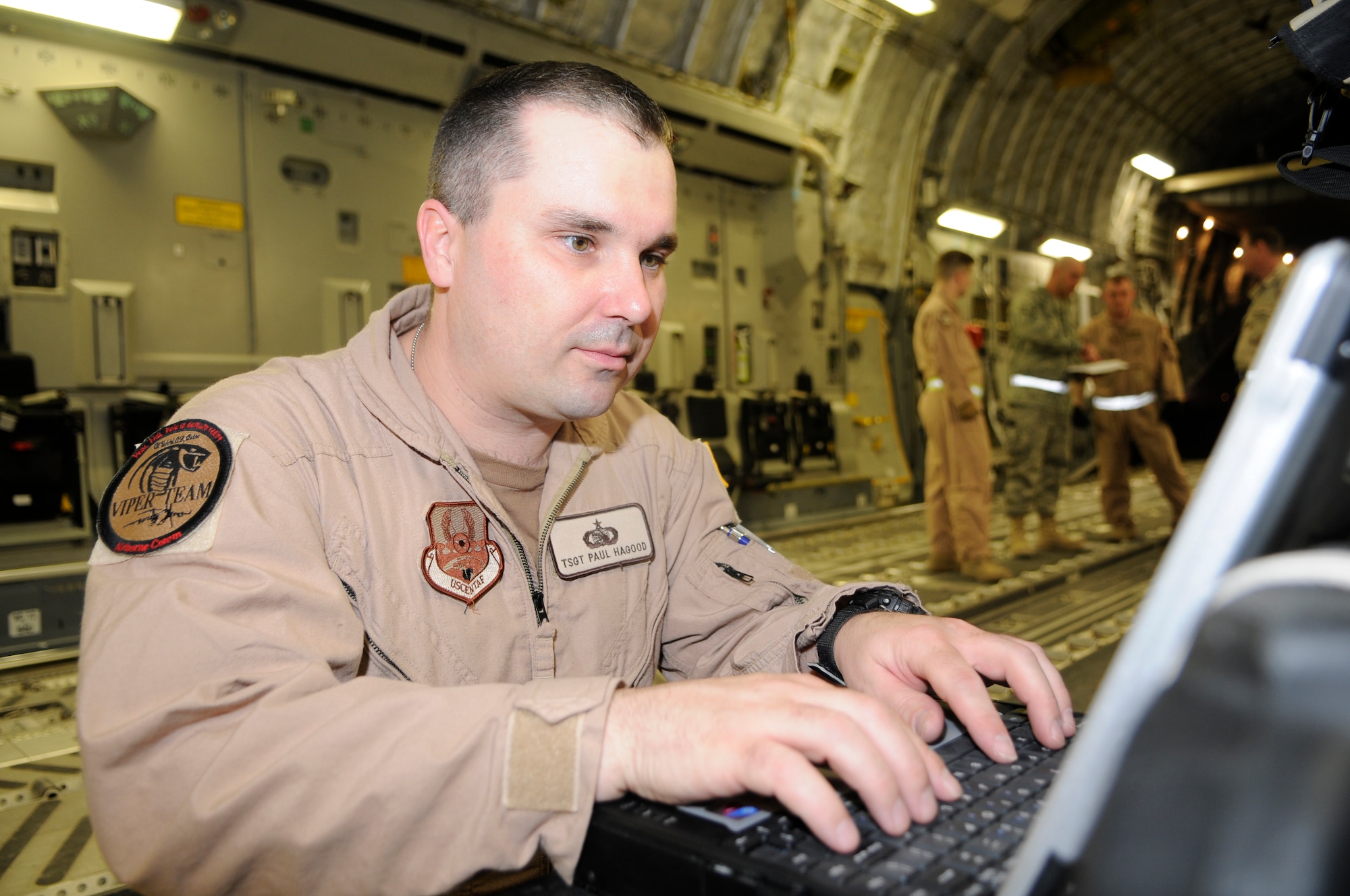 Tech Sgt. Paul D. Hagood, 379th Expeditionary Communications Squadron, monitors the Viper system while on a C-17 at a Southwest Asia air base Feb 19. Sergeant Hagood is able to monitor the aircraft position, signal strength, and equipment status. He is deployed from Schriever Air Force Base, Colo. (U.S. Air Force photo/Tech. Sgt. Johnny L. Saldivar)