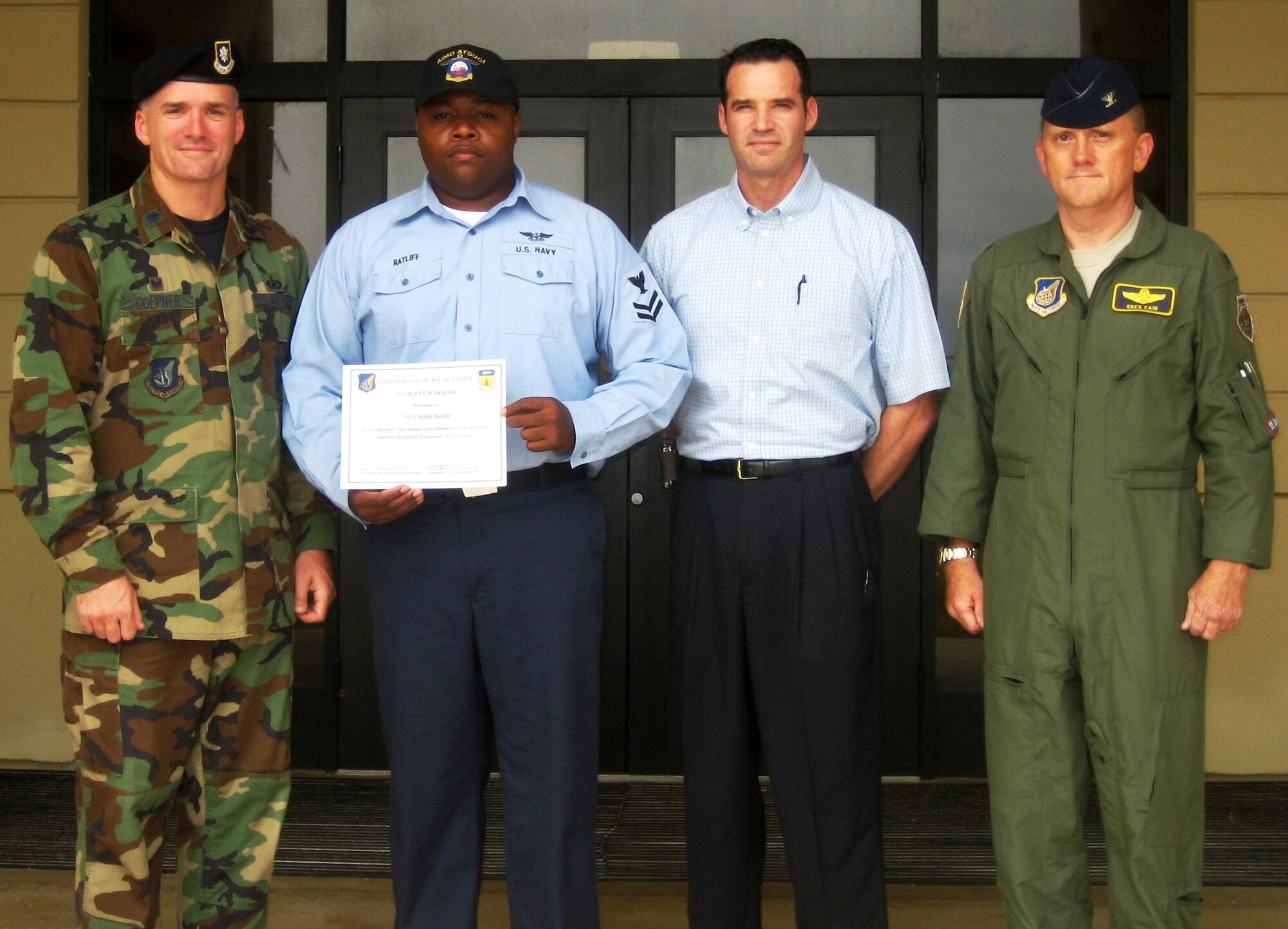 Aviation Support Equipment Technician Second Class Willie L. Ratliff is presented with the Vigilant Warrior certificate by (from left) Lt. Col. Erik Goepner, 36th Security Forces Squadron, Maj. William Wehner, AFOSI Detachment 602 acting commander, and Col. Gregory Cain, 36th Wing vice commander. AS2 Ratliff was awarded the honor after reporting suspicious individuals filming unauthorized footage of the flight line on Feb. 12 in a Vigilant Warrior scenario. (Courtesy photo)