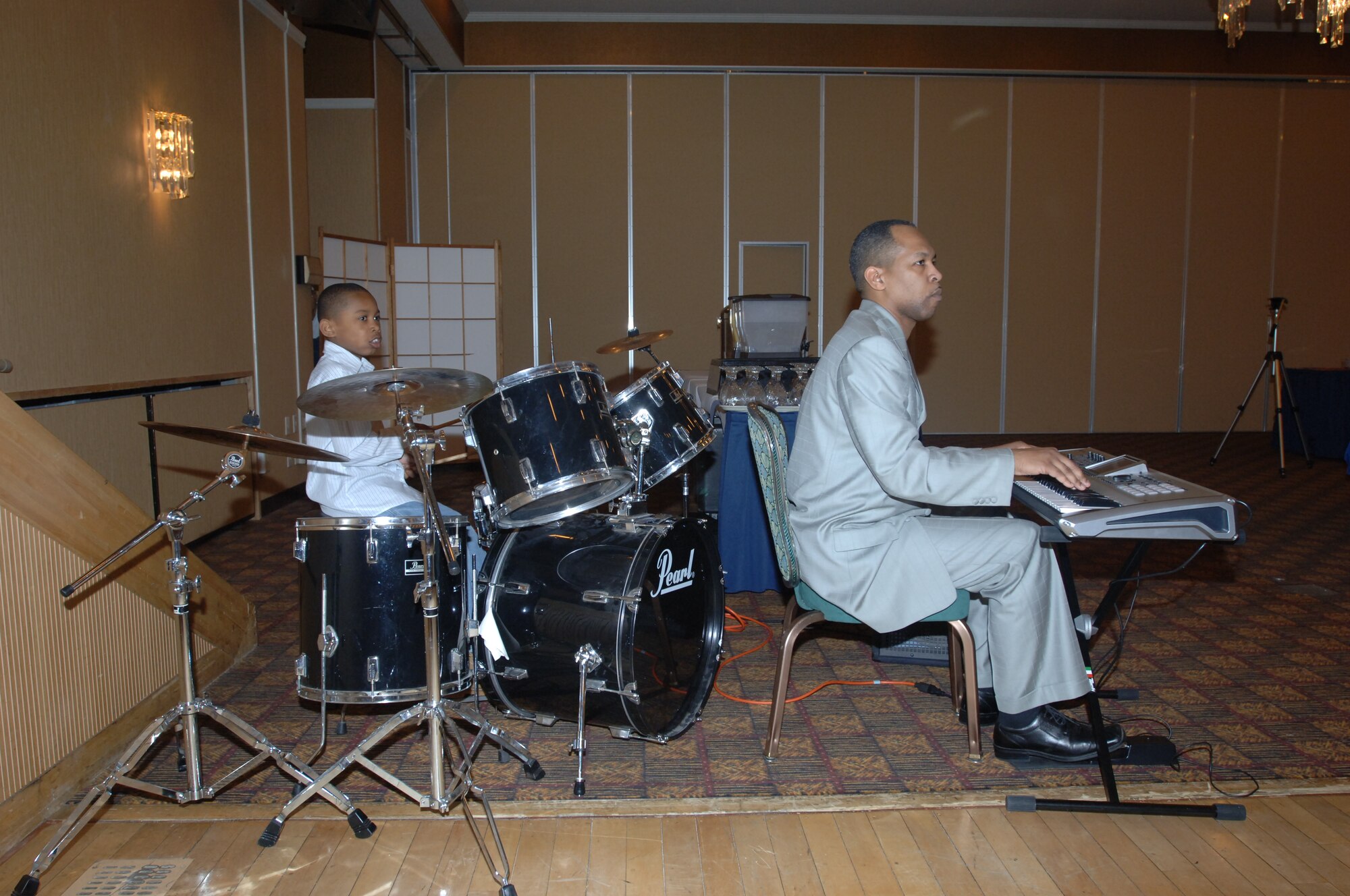 MISAWA AIR BASE, Japan -- Local church pastor Patrick Sledge senior, and his son, Patrick Sledge Junior perform during the annual prayer breakfast at the enlisted club on Feb. 21, 2008.  The prayer breakfast has been a tradition for 66 years, first conducted by the United States Senate and House of Representatives in 1942. (U.S. Air Force photo by Senior Airman Robert Barnett)