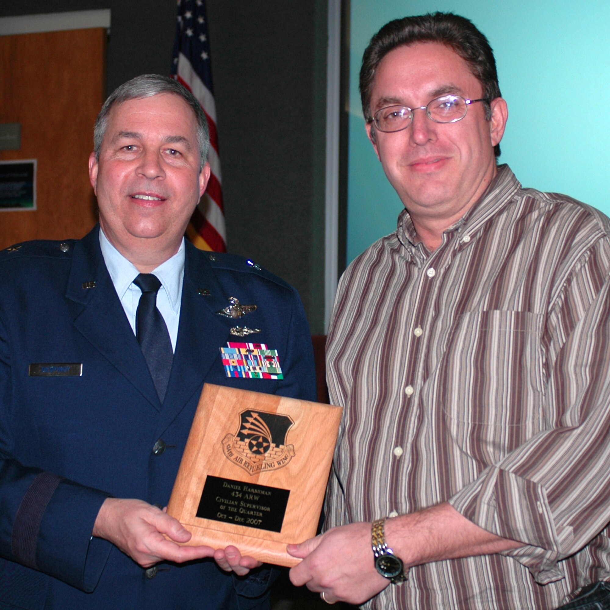GRISSOM AIR RESERVE BASE, Ind., --  Brig. Gen. Dean Despinoy, 434th Air Refueling Wing commander, left, presents Dan Harshman, 434th Communications Squadron, a plaque recognizing him as the 434th Air Refueling Wing's Supervisor of the Quarter. The presentation was made during a special civilian commander's call held recently. (U.S. Air Force photo/Tech. Sgt. Doug Hays)