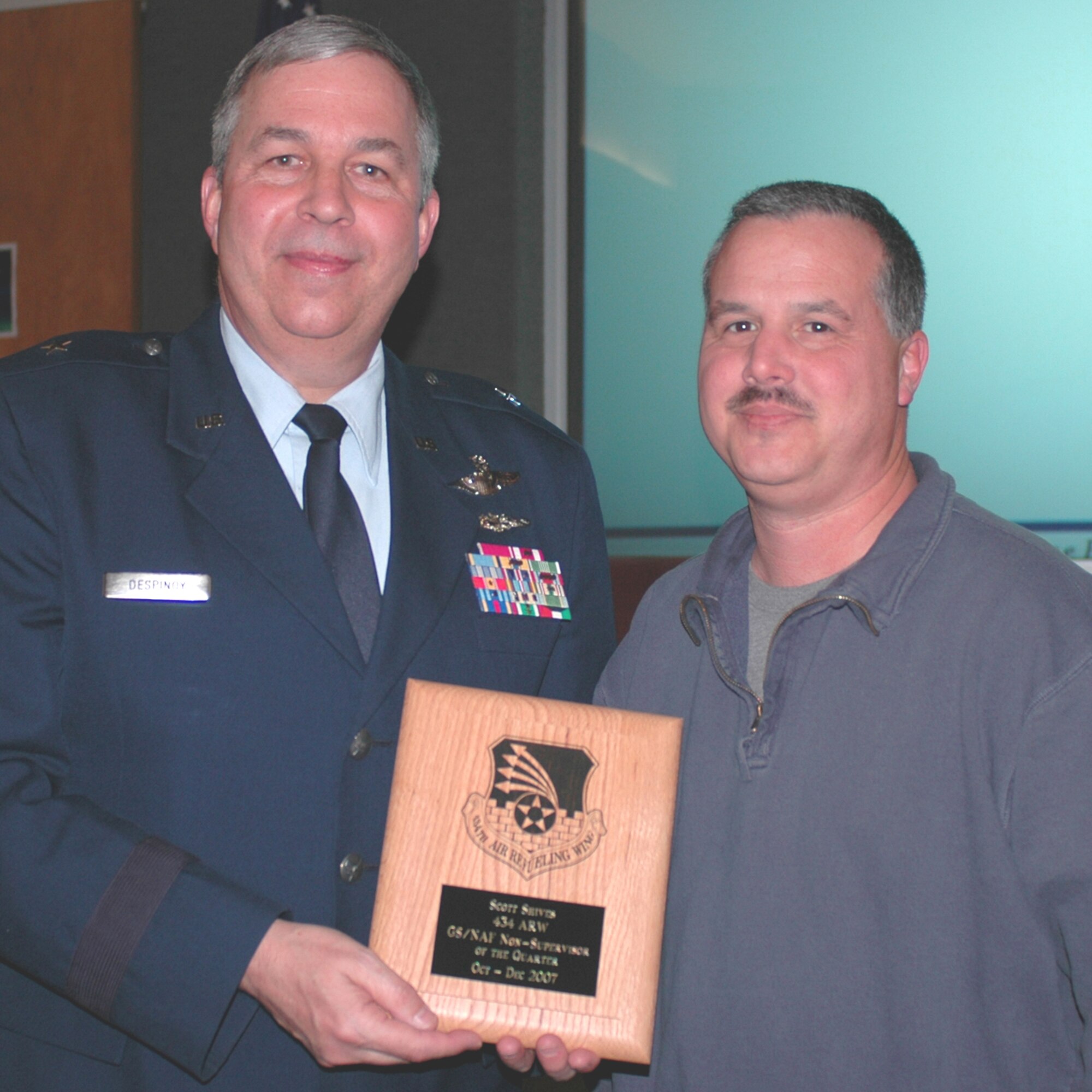 GRISSOM AIR RESERVE BASE, Ind., --  Brig. Gen. Dean Despinoy, 434th Air Refueling Wing commander, left, presents Scott Shives, 434th Communications Squadron, a plaque recognizing him as the 434th Air Refueling Wing's GS/NAF  Non-Supervisor of the Quarter. The presentation was made during a special civilian commander's call held recently. (U.S. Air Force photo/Tech. Sgt. Doug Hays)