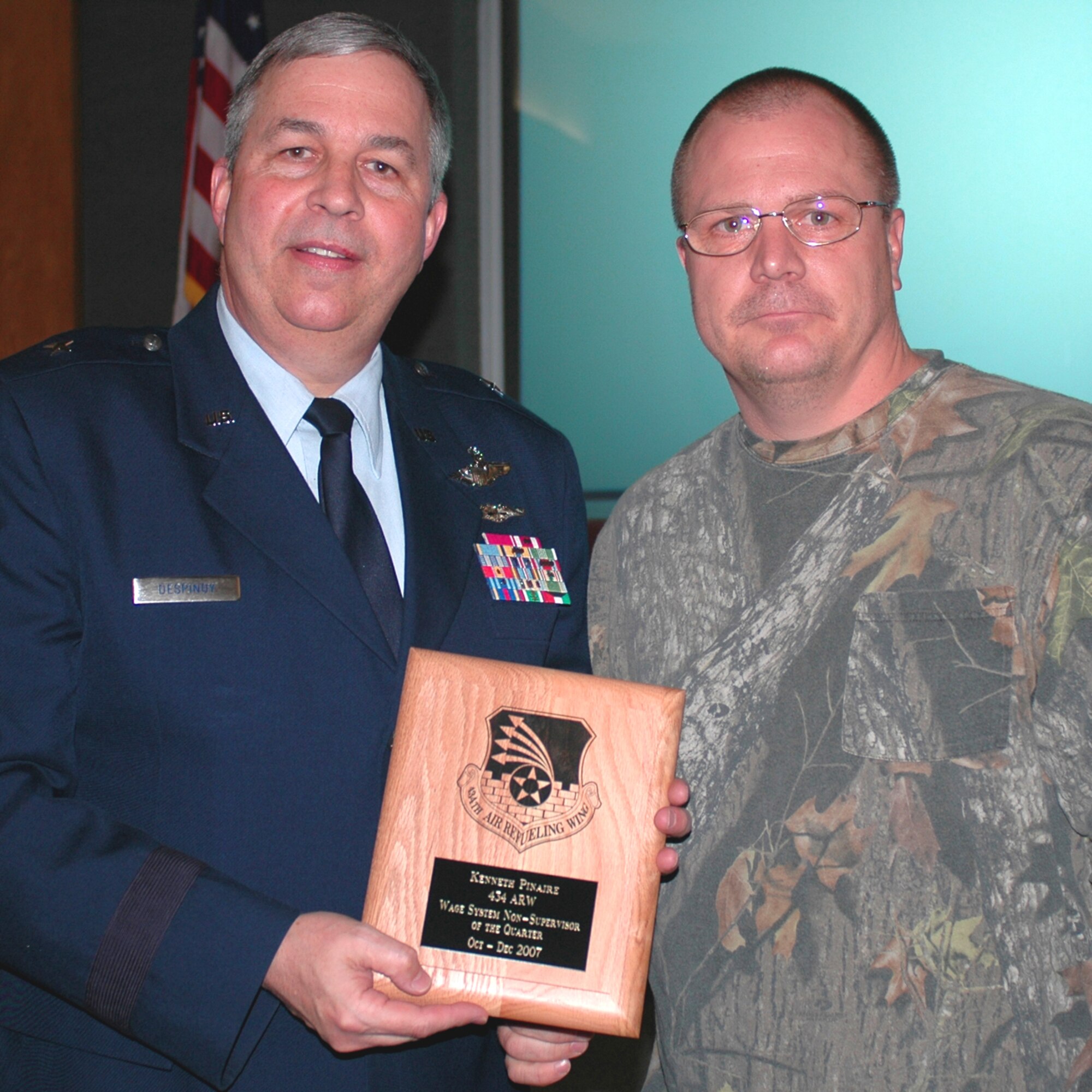 GRISSOM AIR RESERVE BASE, Ind., --  Brig. Gen. Dean Despinoy, 434th Air Refueling Wing commander, left, presents Kenneth Pinaire, 434th Maintenance Squadron, a plaque recognizing him as the 434th Air Refueling Wing's Wage System Non-Supervisor of the Quarter. The presentation was made during a special civilian commander's call held recently. (U.S. Air Force photo/Tech. Sgt. Doug Hays)