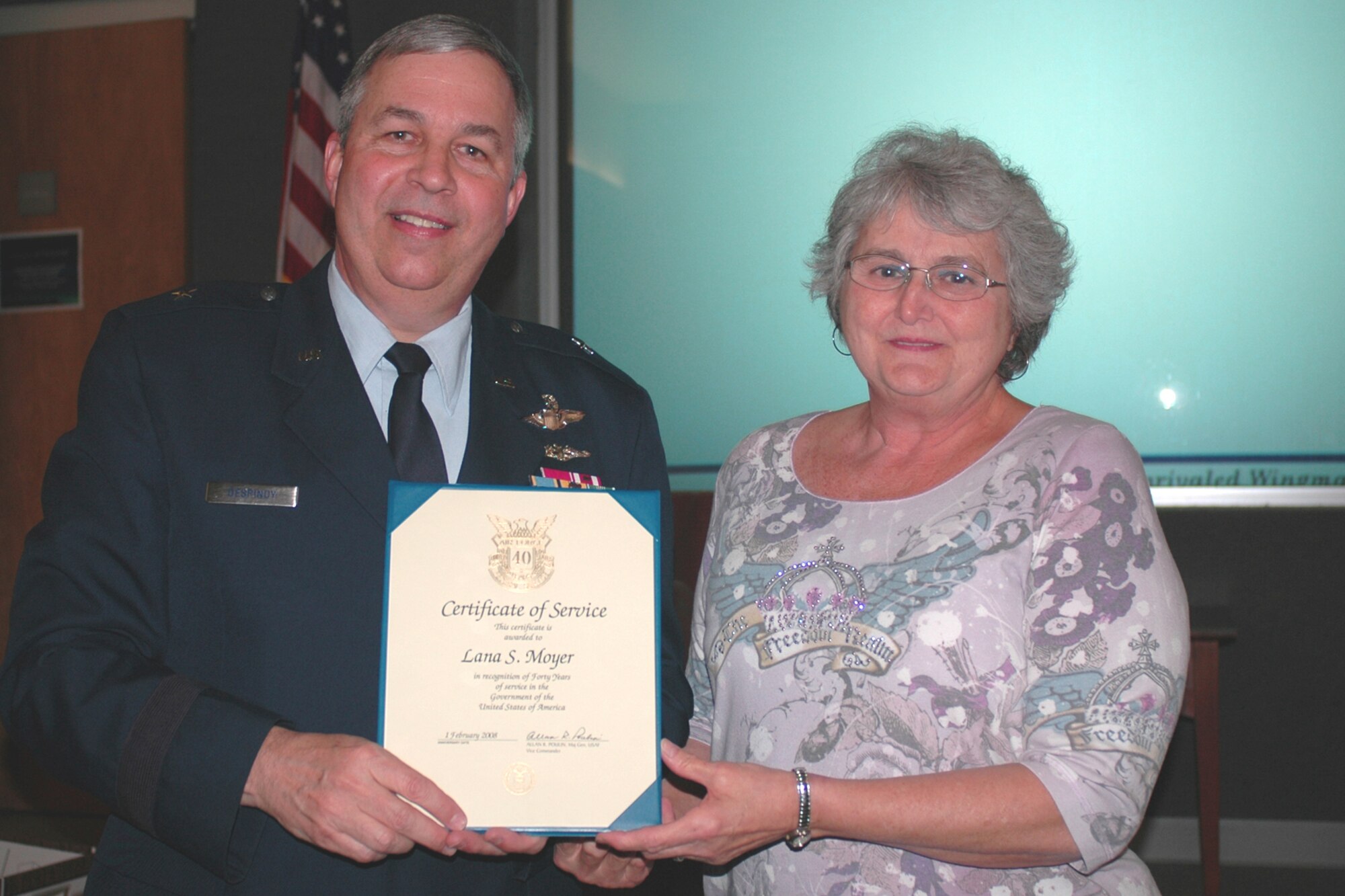 GRISSOM AIR RESERVE BASE, Ind., --  Brig. Gen. Dean Despinoy, 434th Air Refueling Wing commander, left, presents Lana Moyer, 434th Communications Squadron, a certificate marking her 40 years of federal service. The presentation was made during a special civilian commander's call held recently. (U.S. Air Force photo/Tech. Sgt. Doug Hays)