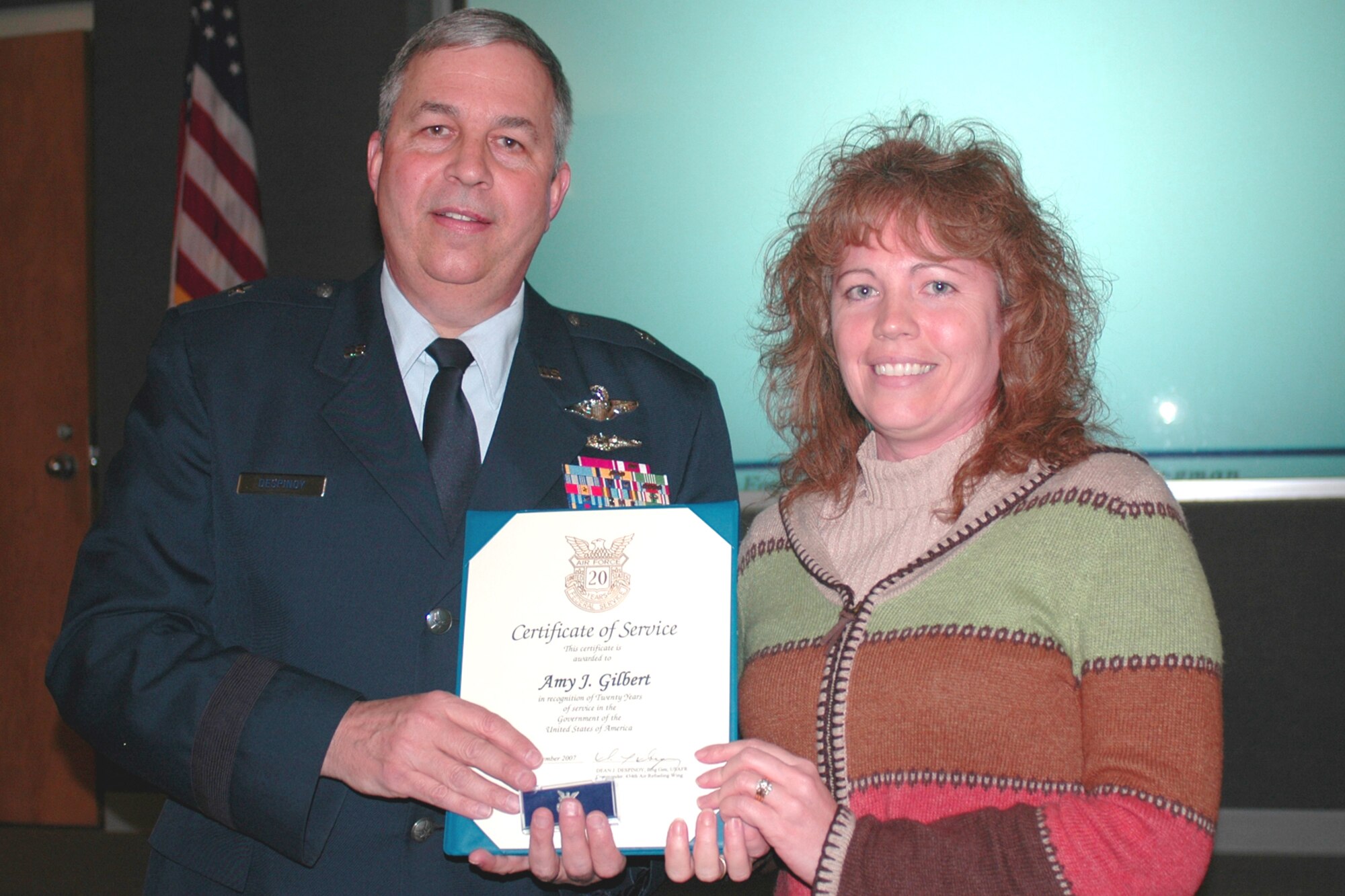 GRISSOM AIR RESERVE BASE, Ind., --  Brig. Gen. Dean Despinoy, 434th Air Refueling Wing commander, left, presents Amy Gilbert, 434th Civil Engineers Squadron, a certificate marking her 20 years of federal service. The presentation was made during a special civilian commander's call held recently.  (U.S. Air Force photo/Tech. Sgt. Doug Hays)