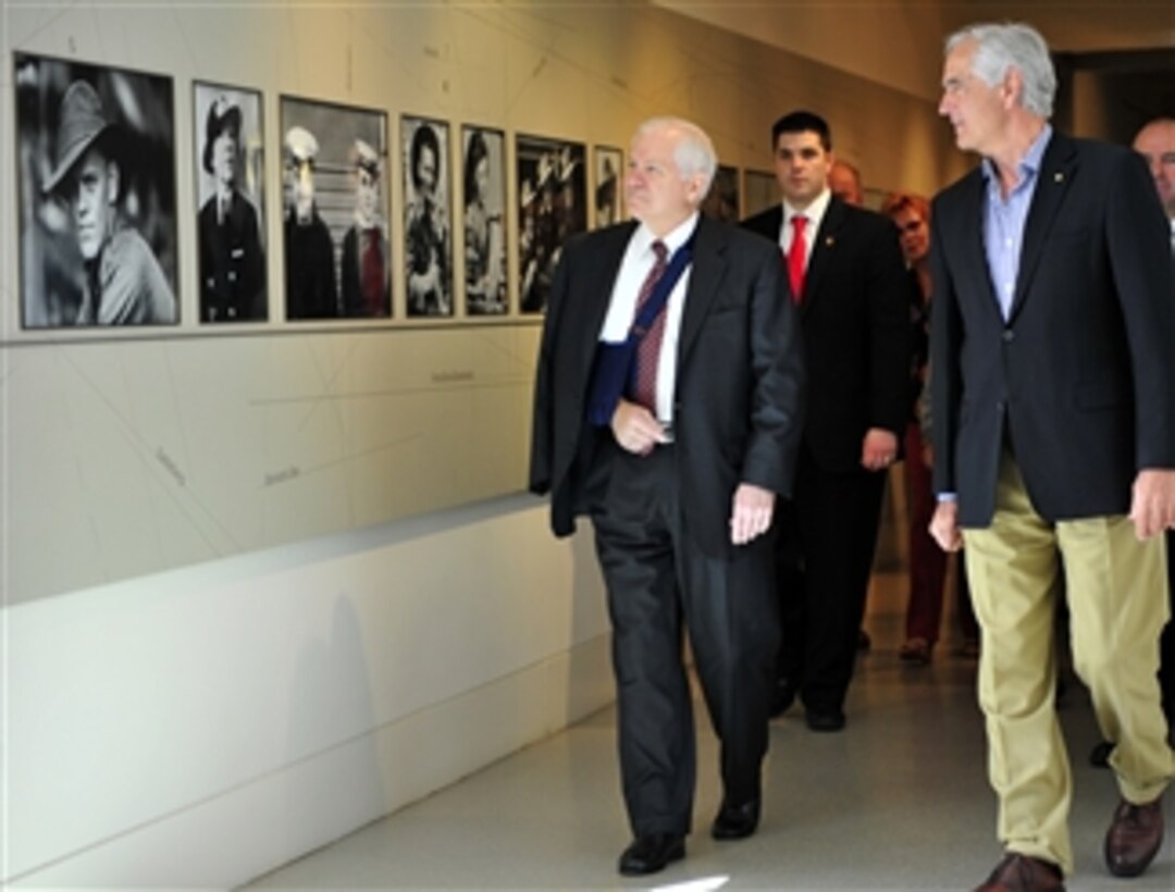 U.S. Defense Secretary Robert M. Gates, left, looks at photographs during a tour of the Australian War Memorial in Canberra, Australia, with retired Australian Maj. Gen. Steve Gower, director of the Australian War Memorial, Feb. 24, 2008.  