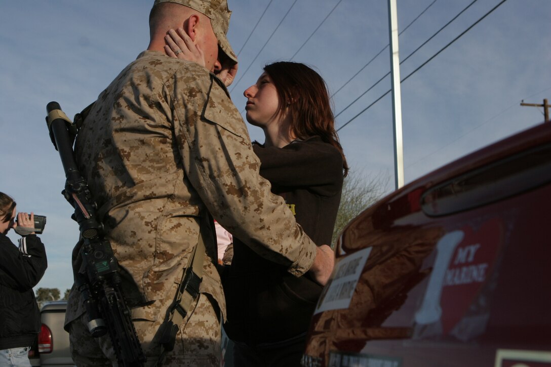 Lance Cpl. Jimmie DeMarco, a Grand Terrace, Calif., native with Kilo Company, 3rd Battalion, 4th Marine Regiment, spends a final moment with his wife, Krystalyn, before setting off on a seven-month deployment to Iraq Feb. 25, 2008, at the Combat Center.  3/4, also nicknamed ?Darkside? for their call sign they adopted during the beginning of Operation Iraqi Freedom, will be deploying to western Al Anbar Province, Iraq.  They are tasked with mentoring, monitoring and training the Iraqi security forces, maintaining security and assisting the local leaders to become better governing officials for their local government.