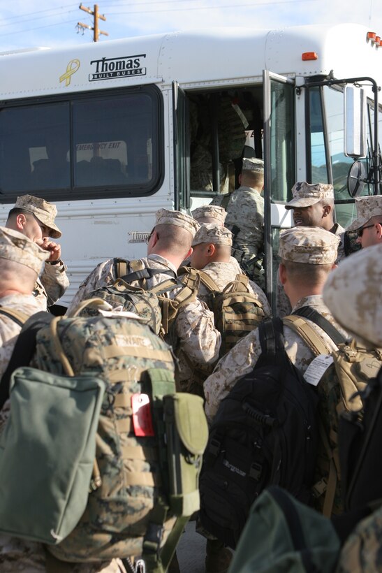 U.S. Marines and sailors with 3rd Battalion, 4th Marine Regiment, load on to a bus and depart from the Combat Center on a seven-month deployment to Iraq Feb. 25, 2008.  3/4, also nicknamed ?Darkside? for their call sign they adopted during the beginning of Operation Iraqi Freedom, will be deploying to western Al Anbar Province, Iraq.  They are tasked with mentoring, monitoring and training the Iraqi security forces, maintaining security and assisting the local leaders to become better governing officials for their local government.