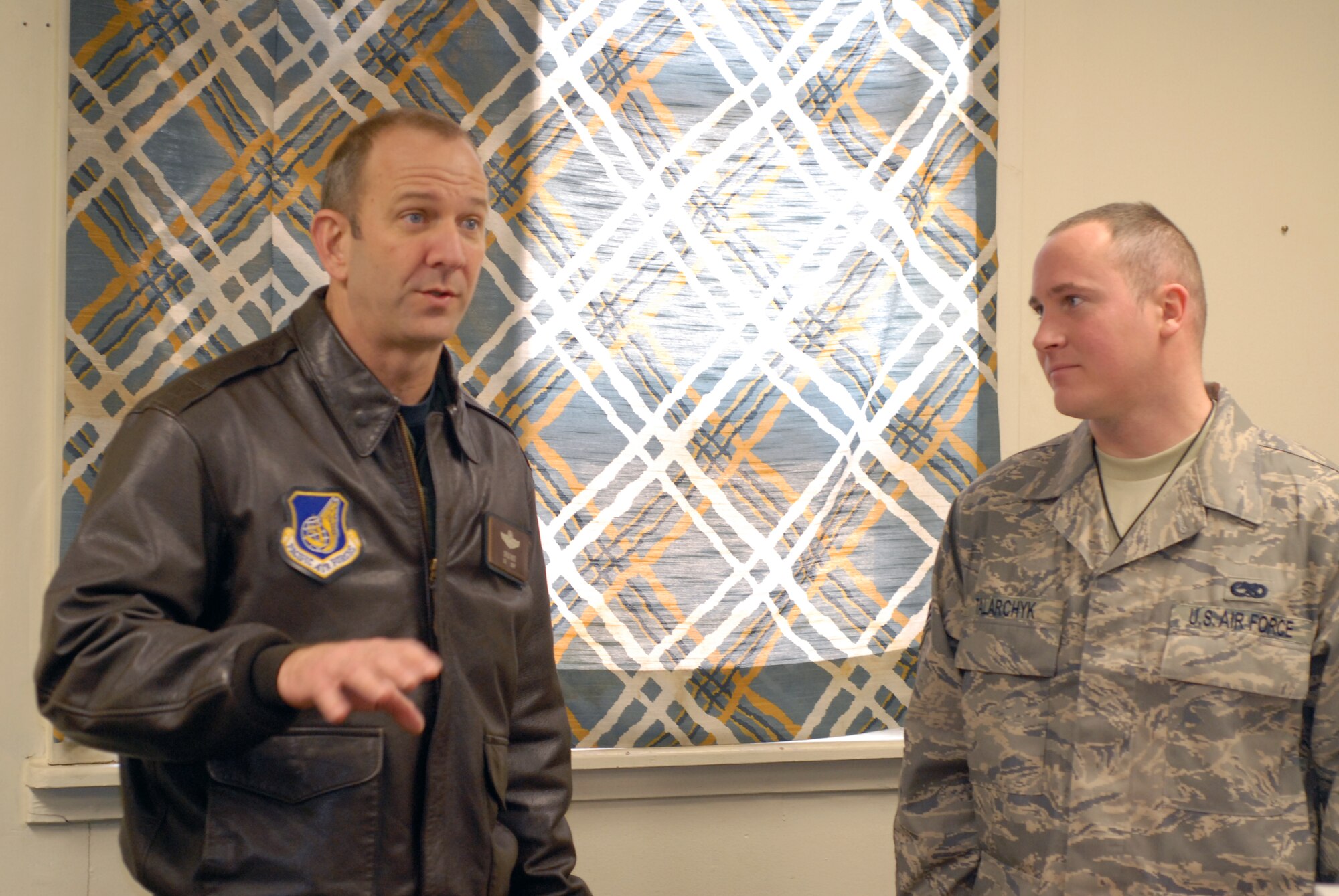 KUNSAN AIR BASE, South Korea --  Colonel Creig Rice 8th Fighter Wing vice commander, congratulates Senior Airman Randall Talarchyk from the 8th Maintenance Operations Squadron here Feb. 22. Airman Talarchyk was selected as the 8th Fighter Wing's Pride of the Pack for the week of Feb. 18. (U.S. Air Force photo/Staff Sgt. Alice Moore) 