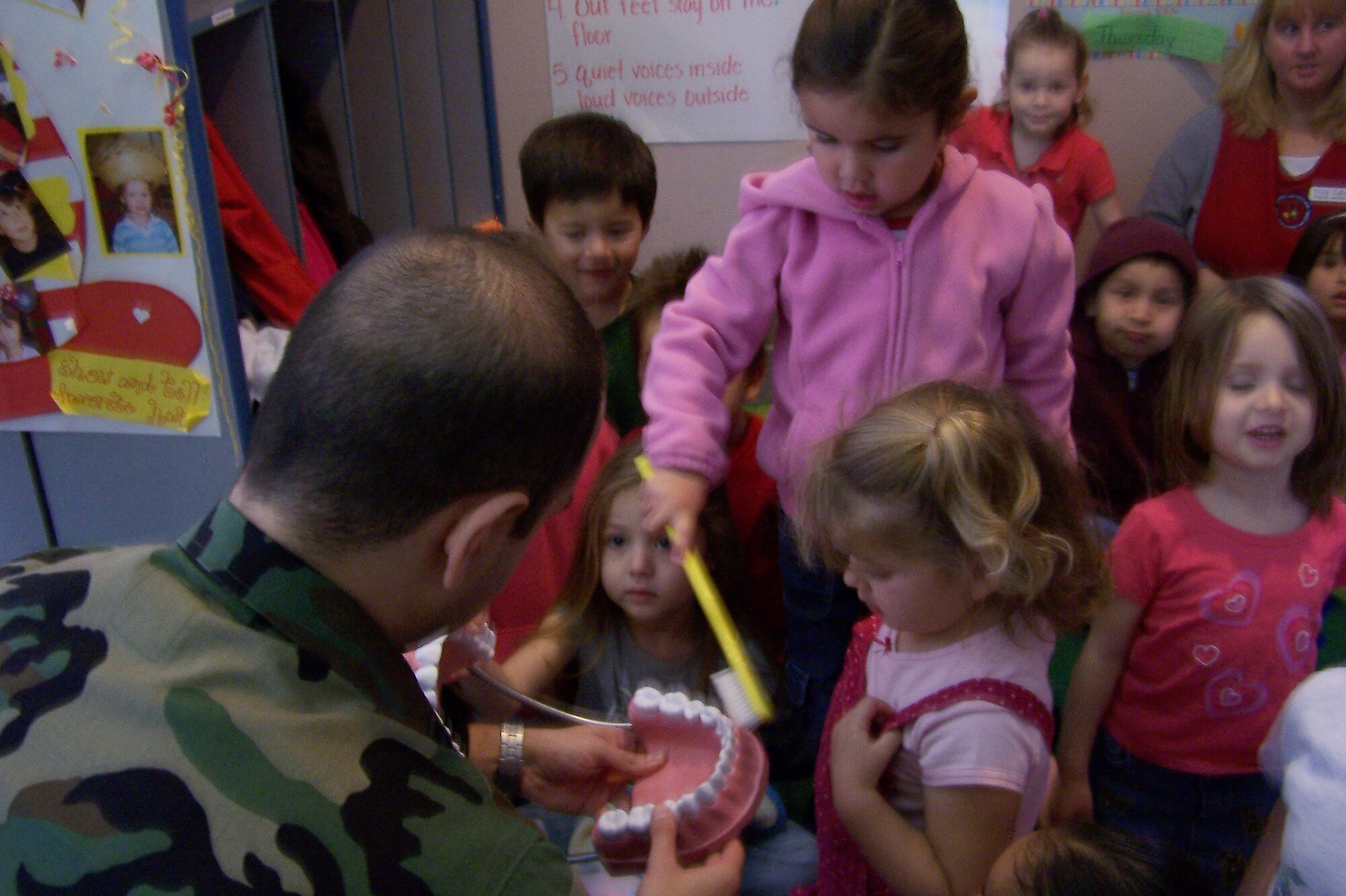 VANDENBERG AIR FORCE BASE, Calif. --  Capt. Varun Narula, a dentist with the 30th Medical Operations Squadron here, has children demonstrate how to properly brush teeth recently. Captain Narula and other dental flight Airmen visited the Youth Center and Child Development Center as part of National Children's Dental Health Month. (Courtesy photo)