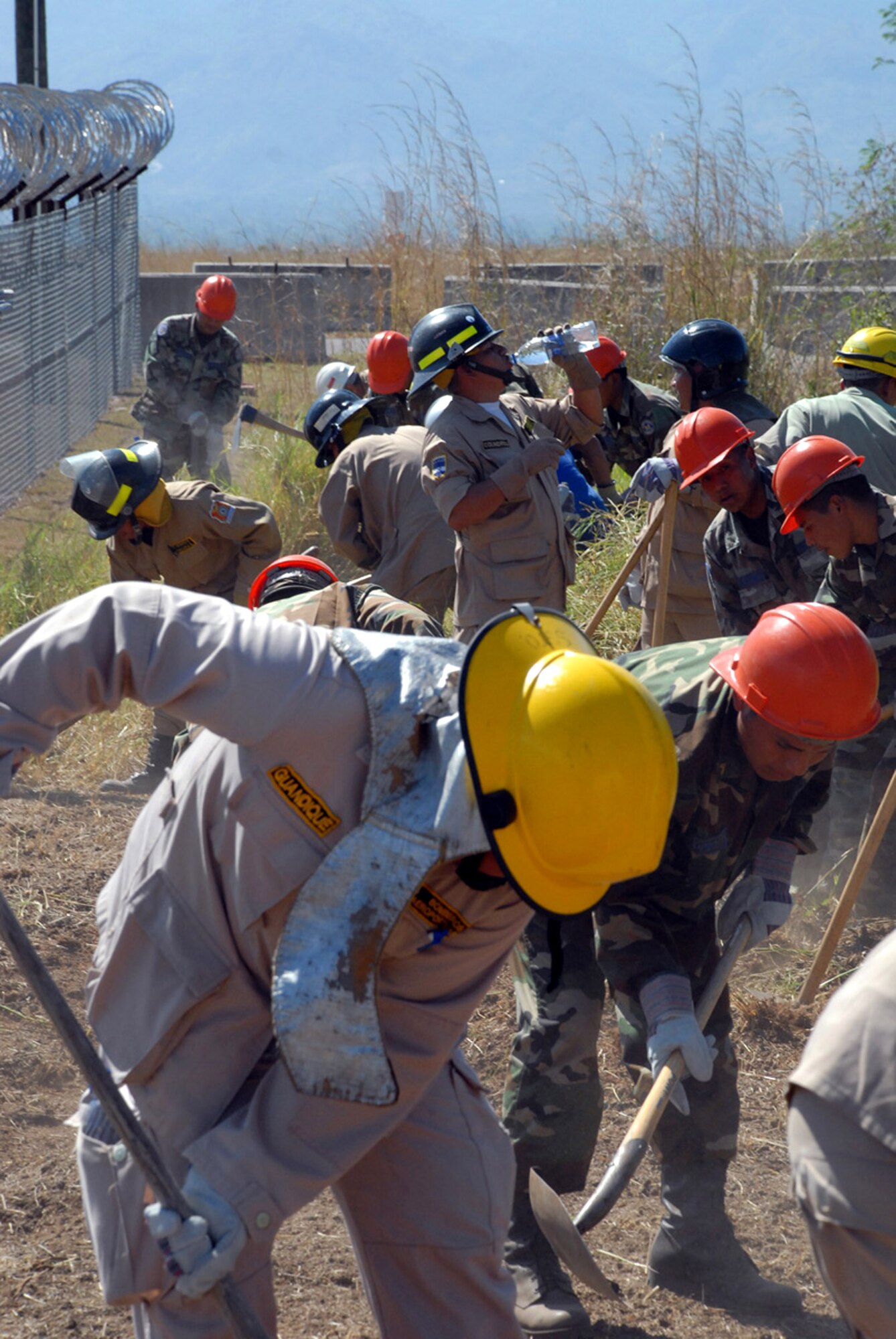 Honduran military and civilian firefighters dig a fire break at Soto Cano Air Base, Honduras. The firefighters are participating in a Joint Task Force-Bravo-sponsored firefighting subject matter expert exchange. During the exchange, a learning exposition for U.S. and Honduran firefighters, a great level of importance is placed on land navigation and fighting wildfires. (U.S. Air Force photo/Tech. Sgt. William Farrow) 