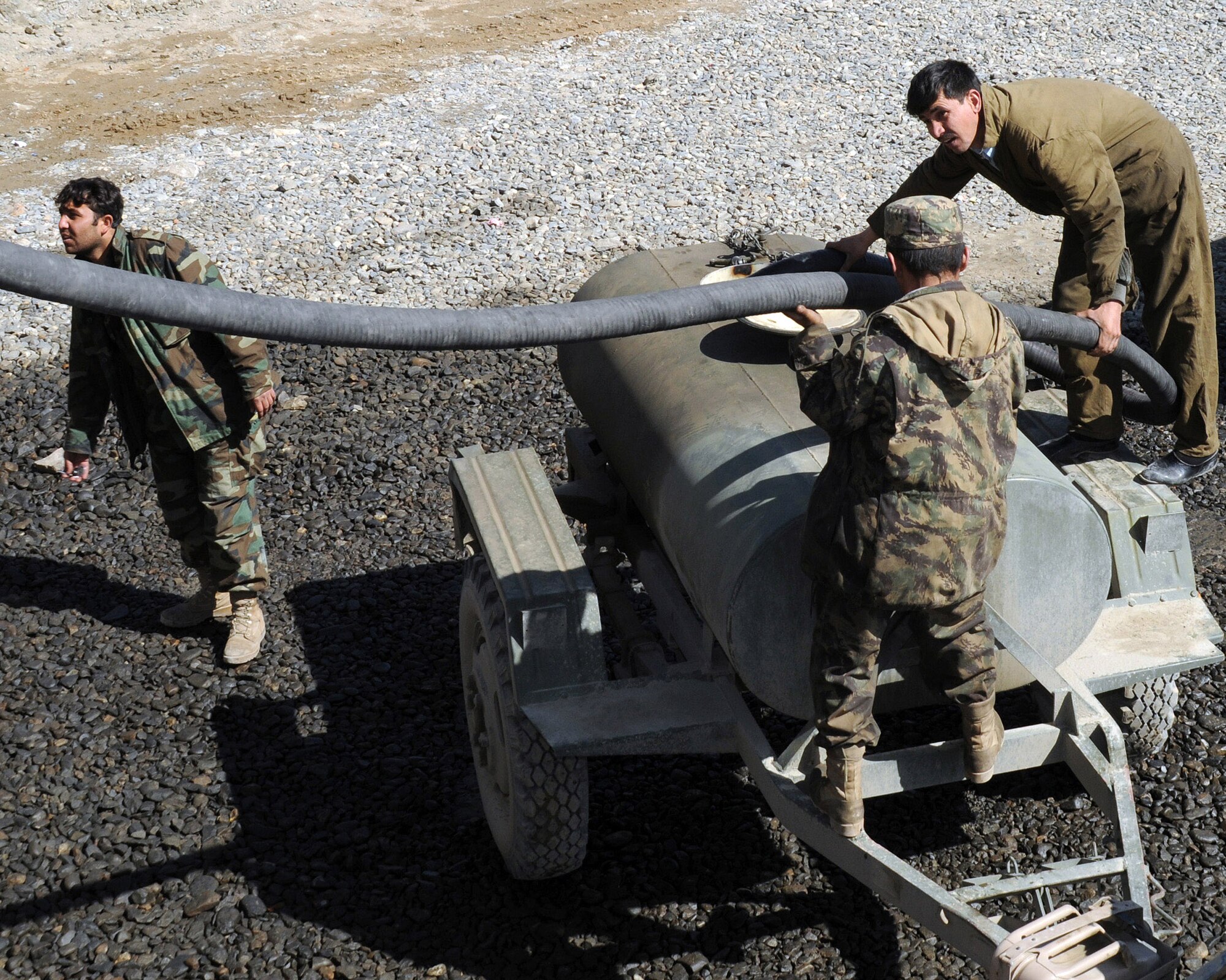 Afghan national army soldiers pump fuel at the Class 3 depot Feb. 23 in Kabul, Afghanistan. The depot distributes gasoline, diesel fuel and fire wood to ANA and Afghan national police from throughout the country. The ANA are mentored by American Airmen. (U.S. Air Force photo/Staff Sgt. Ian Carrier)