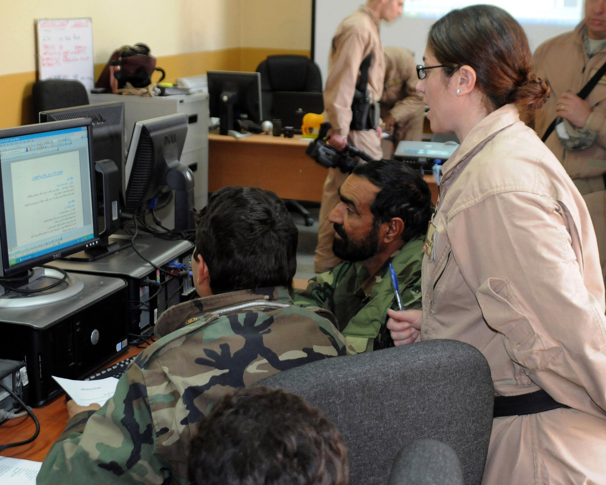 Tech. Sgt. Natalie Cerchio gives computer instruction to an Afghan national army colonel Feb. 20 at Kabul, Afghanistan. Sergeant Cerchio, assigned to the 755th Expeditionary Support Squadron, is one of the Airmen mentors who work with ANA soldiers to help them improve upon their logistics skills. Part of the training is to teach them to use computers to track their supplies. (U.S. Air Force photo/Staff Sgt. Ian Carrier)
