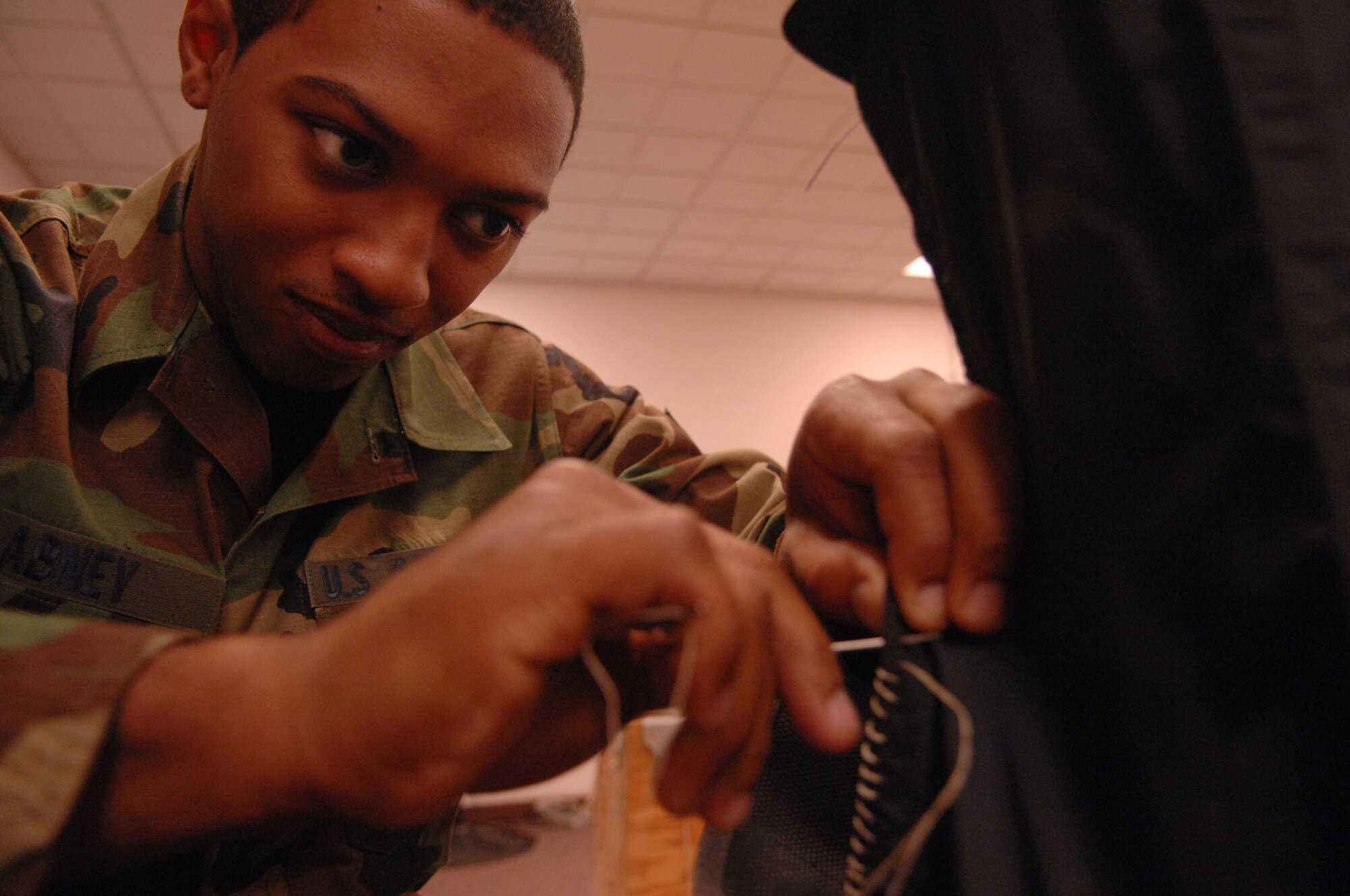 MOODY AIR FORCE BASE, Ga. -- Airman 1st Class Antonio Abney, 23rd Operations Support Squadron aircrew flight equipment apprentice, 'whip stitches' a protective cover on an ACES II ejection seat recovery parachute container Feb. 20 here. The parachute will then be packed and placed into a Moody assigned A-10C Thunderbolt II. (U.S. Air Force photo by Airman 1st Class Gina Chiaverotti)   