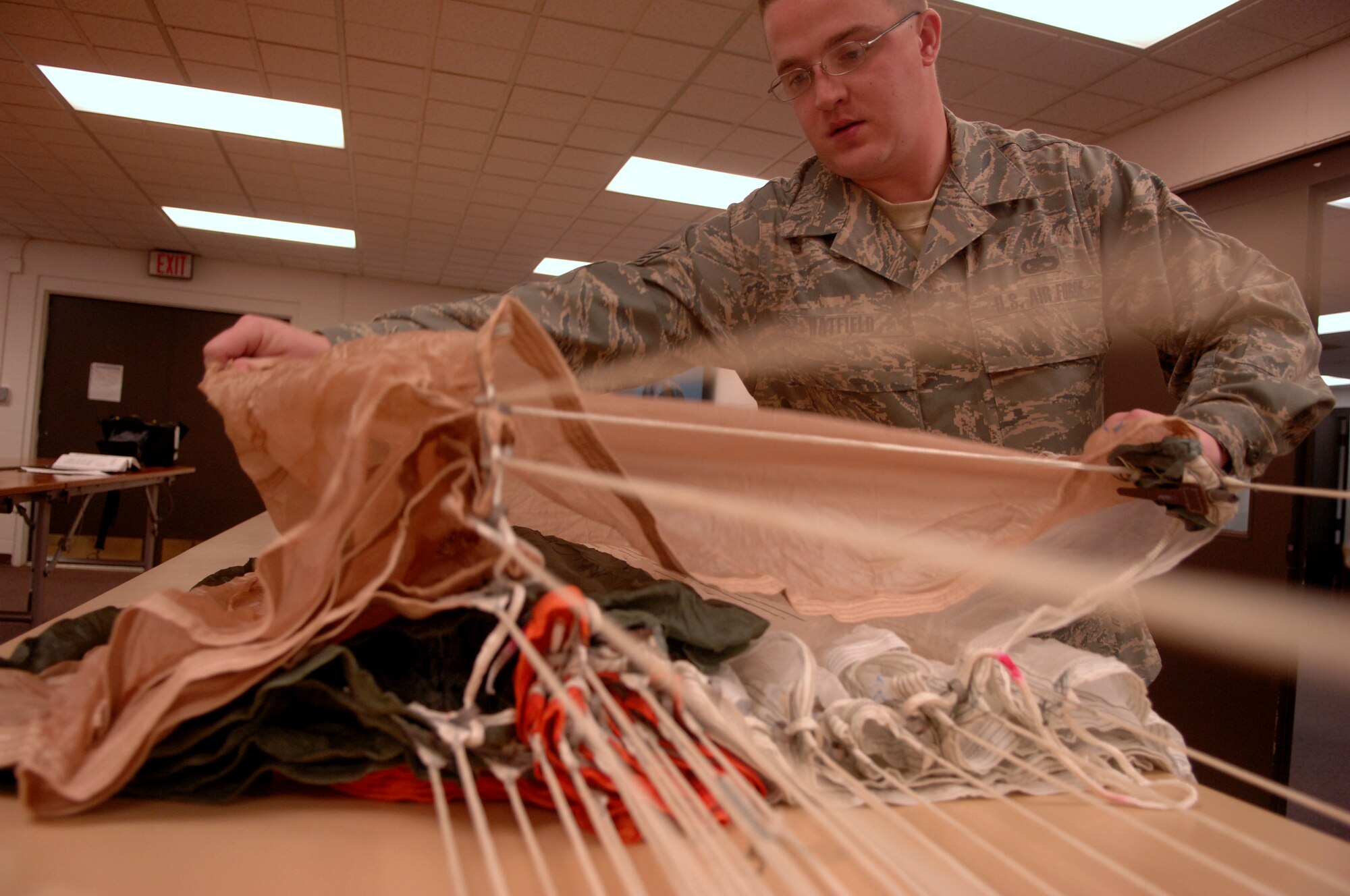 MOODY AIR FORCE BASE, Ga. -- Staff Sgt. Brandon Hatfield, 23rd Operations Support Squadron aircrew flight equipment craftsman, performs an in-process inspection Feb. 20 here. The inspection verifies the proper sequence in the ACES II ejection seat's parachute suspension lines and must be performed by a senior craftsman. (U.S. Air Force photo by Airman 1st Class Gina Chiaverotti)