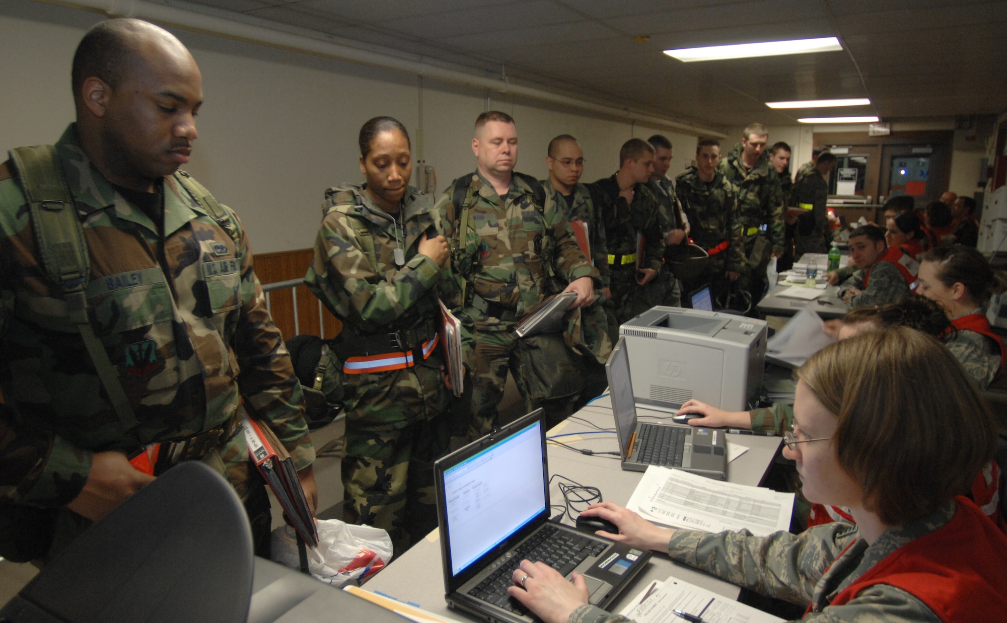 MOUNTAIN HOME AIR FORCE BASE, Idaho - Airmen from the 366th Fighter Wing proceed through the personnel deployment function line while staff members assist them with finalizing their mobility folders during Exercise Sharpshooter 08-04 Feb. 25. Mobility folders are used to consolidate and streamline the process. The 366th Fighter Wing conducts exercises to prepare personnel and equipment for the upcoming March 2008 Operational Readiness Inspection. (U.S. Air Force photo/ Airman 1st Class Stephany Miller)