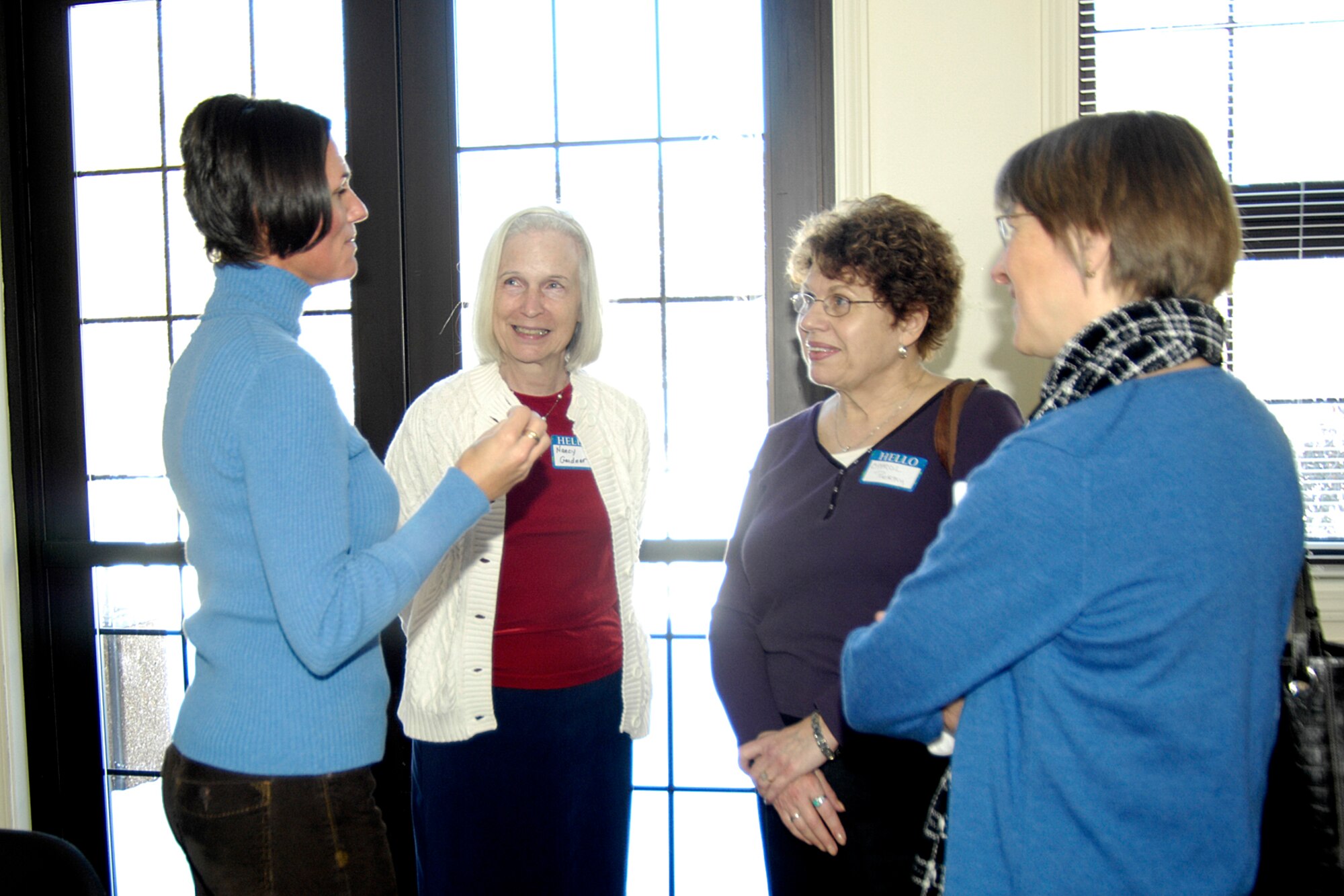 HANSCOM AFB Mass. -- Staff Sergeant Susan Ellis (far left), 66th Security Forces Squadron investigator, speaks to a group of women from an amateur crime novel writers society, “Sisters in Crime.” Sergeant Ellis, along with Maj. Tamara Mayer, 66 SFS commander, spoke to the group of women Feb. 24 about their experiences as crime fighters in the service. (U.S. Air Force photo by Linda LaBonte Britt)