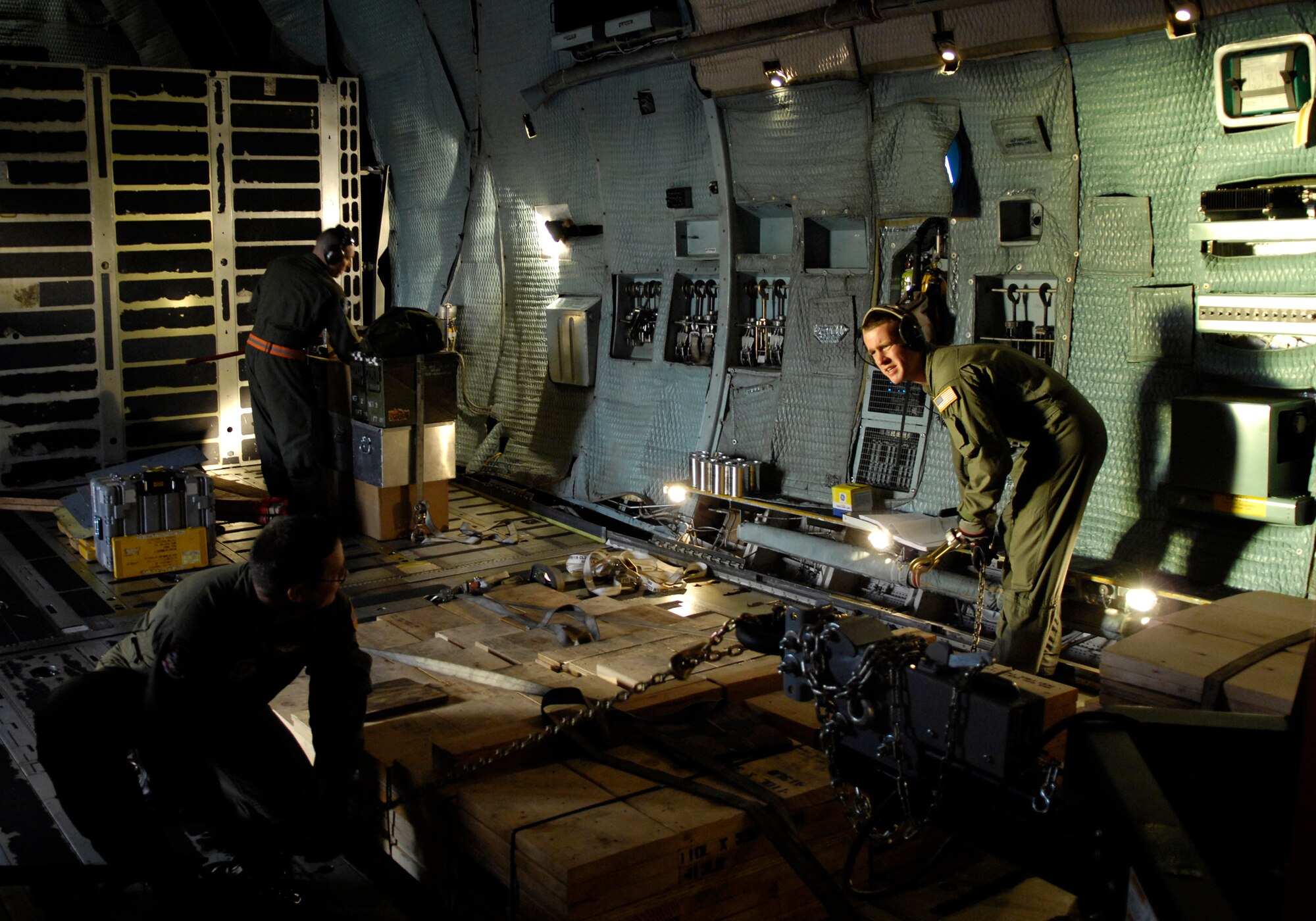 VANDENBERG AIR FORCE BASE, Calif. -- Master Sgt. Tracy Stocks and Senior Airman Robert Allbright, 22nd Airlift Squadron, Travis AFB, Calif., tie down cargo on a C-5 Galaxy on Feb. 15. Thirty-six Airmen from the 30th Space Wing were deployed in support of Joint Task Force-Burnt Frost recently. (U.S. Air Force photo by Airman 1st Class Jonathan Olds)
