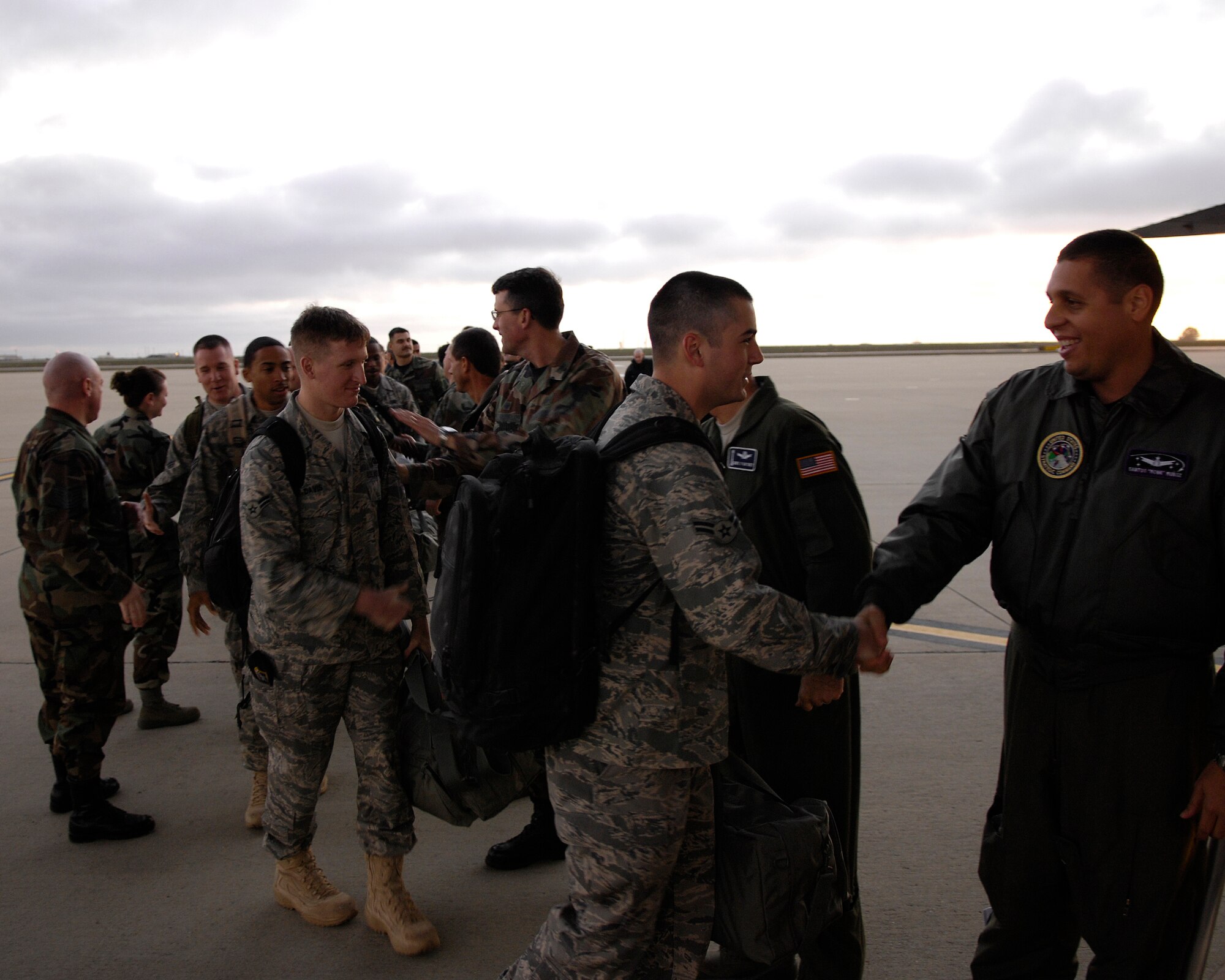 VANDENBERG AIR FORCE BASE, Calif. -- Maj. Santos Munoz, Joint Functional Component Command for Space, and other Vandenberg leadership, give farewells to Airmen boarding a C-5 Galaxy headed to McGuire AFB, N.J., on Feb. 15. Thirty-six Airmen from the 30th Space Wing were deployed in support of Joint Task Force-Burnt Frost recently. (U.S. Air Force photo by Airman 1st Class Jonathan Olds)