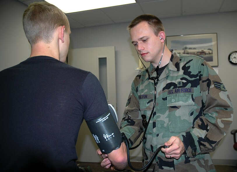 Senior Airman Christopher P. Walton (right), 919th Med-ical Squadron medical services journeyman, screens Airman 1st Class James P. Brock III for hypertension by assessing his blood pressure. The 919th MDS garnered an overall rating of ?Outstanding? during a health services inspection conducted on Duke Field Jan. 31 ? Feb. 3. (U.S. Air Force Photo/Jasmine DeNamur)