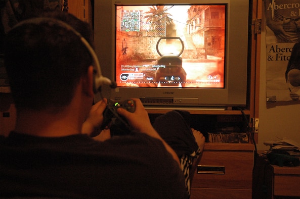 Airman 1st Class Christopher Tyminski, 325th Air Control Squadron weapons technician, plays Call of Duty 4: Modern Warfare in his room.  The screen goes red when a player is getting shot at. (U.S. Air Force photo by Airman 1st Class Anthony J. Hyatt) 