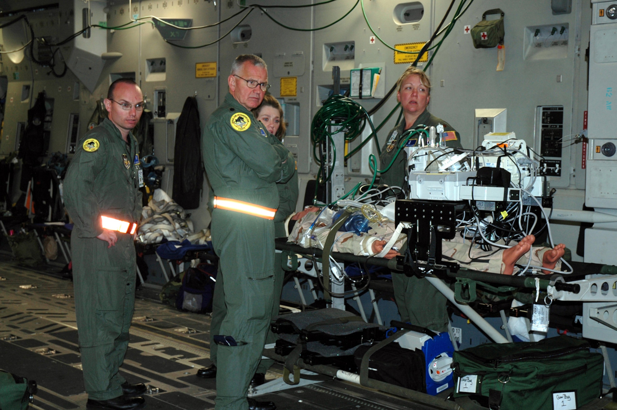 Tech. Sgt. Shawn Bovee, (left to right) Lt. Col. Eric Johnson, and Maj. Jenifer Cackler,  446th Aerospace Staging Squadron, make up the Critical Care Air Transport Team that participated in the Pacific Lifeline exercise Jan. 26 to Feb. 9.  Pacific Lifeline was a humanitarian assistance disaster response exercise that took place on three Hawaiian Islands.  More than 900 Department of Defense personnel participated, including 145 Air Force Reserve Airmen from the 446th Airlift Wing, McChord Air Force Base, Wash. (U.S. Air Force photo/Capt. Jennifer Gerhardt)