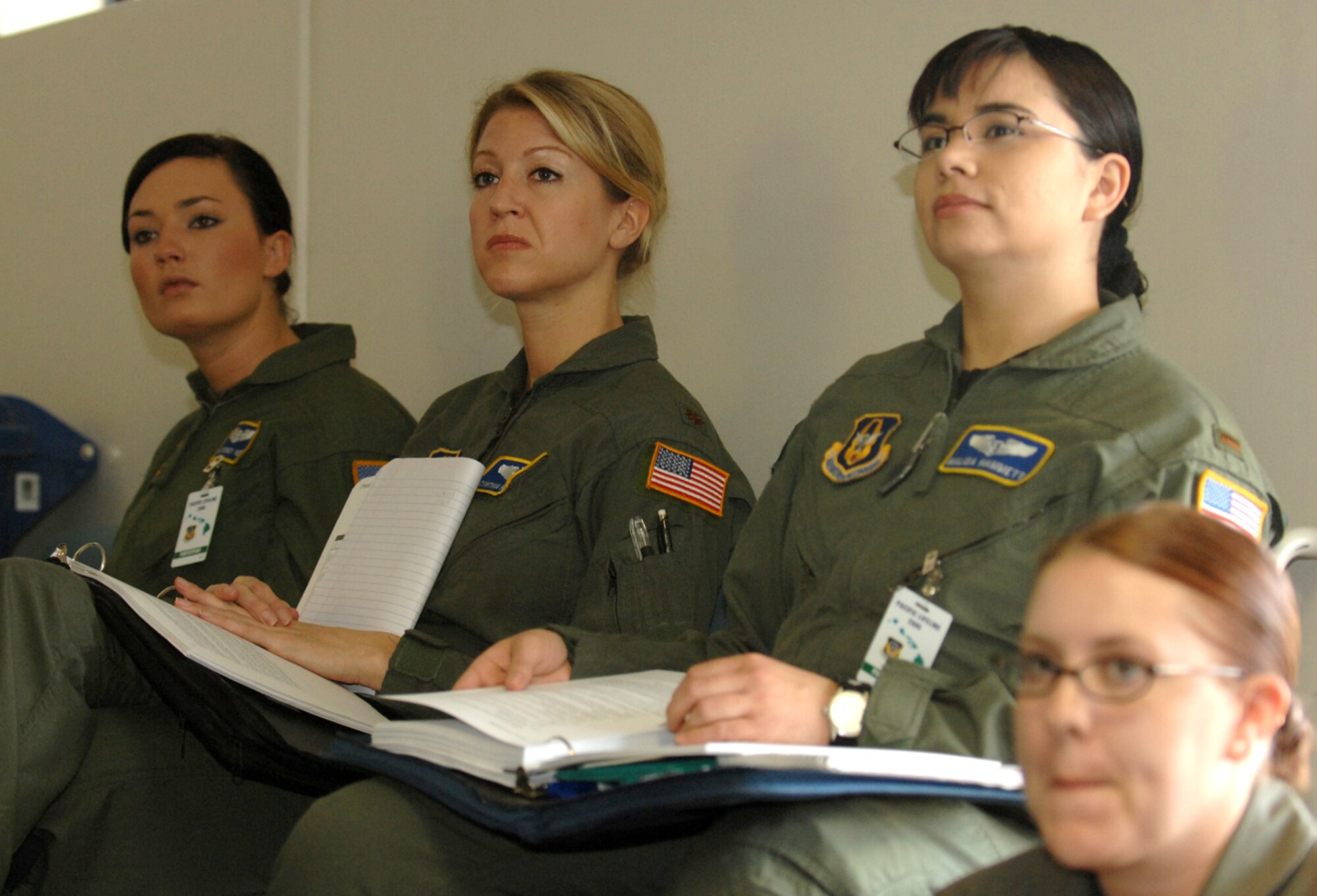 Senior Airman Sydney Reed, (left to right) Maj. Cynthia Hathaway, 2nd Lt. Malissa Hammet, and Staff Sgt. Allison Massey, 446th Aeromedical Evacuation Squadron, McChord Air Force Base, Wash., listen to a briefer during a training session in the first week of the Pacific Lifeline exercise.  Pacific Lifeline was a humanitarian assistance disaster response exercise that took place on three Hawaiian Islands Jan. 26 to Feb. 9.  More than 900 Department of Defense personnel participated, including 145 Air Force Reserve Airmen from McChord. (U.S. Air Force photo) 