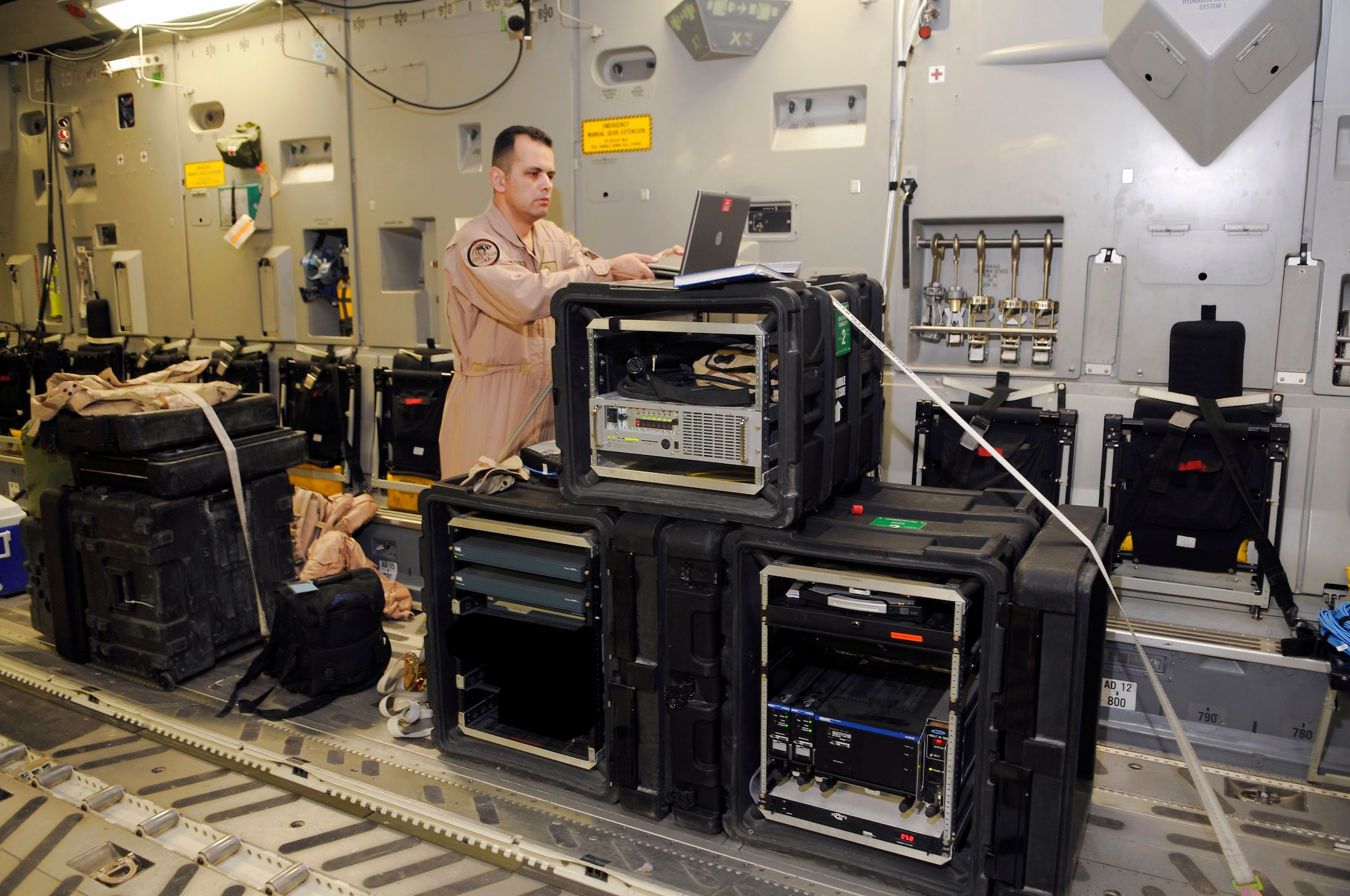 Staff Sgt. Roland Bazan performs an operational check of a secure internet network Feb 19 while on board a C-17 Globemaster III in Southwest Asia. Sergeant Bazan ensures everything is operable before the aircraft takes off. Sergeant Bazan is a member of the 379th Expeditionary Communications Squadron and is deployed from Schriever Air Force Base, Colo. (U.S. Air Force photo/Tech. Sgt. Johnny L. Saldivar) 