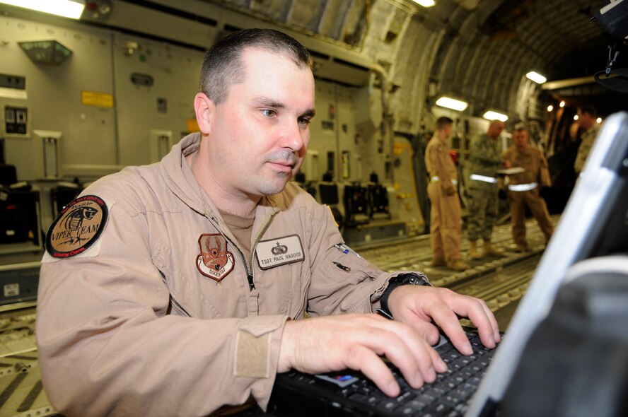 Tech. Sgt. Paul Hagood monitors the Viper system while on a C-17 Globemaster III Feb 19 in Southwest Asia. Sergeant Hagood is able to monitor the aircraft position, signal strength and equipment status. Sergeant Hagood is deployed from Schriever Air Force Base, Colo, to the 379th Expeditionary Communications Squadron. (U.S. Air Force photo/Tech. Sgt. Johnny L. Saldivar)