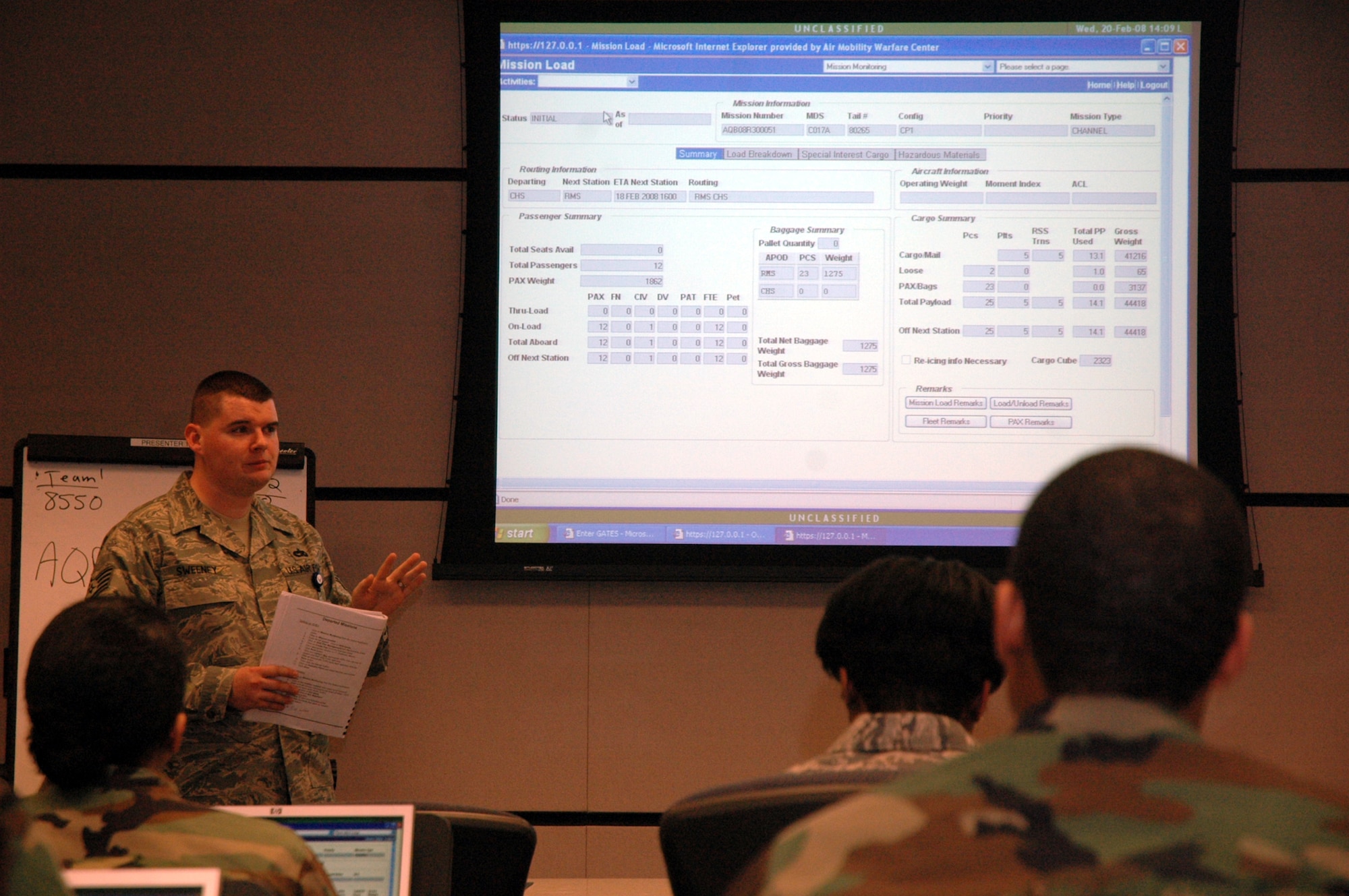 Staff Sgt. Paul Sweeney, instructor for the U.S. Air Force Expeditionary Center's Aerial Port Operations Course 2008E, talks with students as they work on their computers during course instruction inside the Center on Fort Dix, N.J., Feb. 20, 2008.  The course, taught by the Center's Mobility Operations School Air Transportation Branch, teaches Airmen in the Air Force air transportation career field subject areas such as air freight, passenger service, air terminal operations center, and higher headquarters functions.  (U.S. Air Force Photo/Tech. Sgt. Scott T. Sturkol)