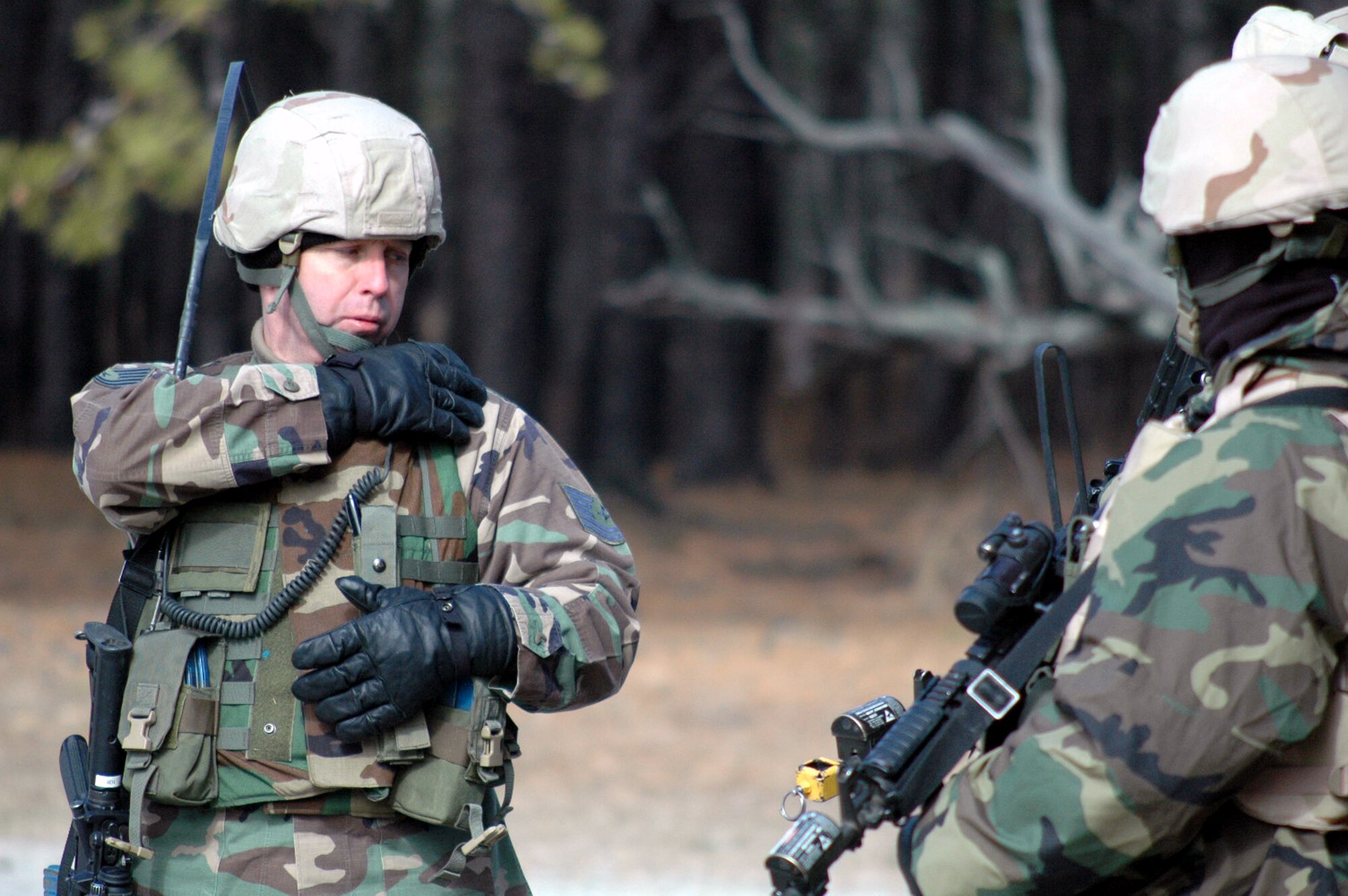 Tech. Sgt. Robert Bolinski, from the 569th U.S. Forces Police Squadron, Vogelweh Air Base, Germany, and a student in the Air Force Phoenix Warrior Training Course 08-3, calls on his radio during a military operations in urban terrain scenario while training on a range Feb. 20, 2008, on Fort Dix, N.J.  The course is taught by the U.S. Air Force Expeditionary Center's Expeditionary Operations School and 421st Combat Training Squadron and prepares security forces Airmen for upcoming deployments.  (U.S. Air Force Photo/Tech. Sgt. Scott T. Sturkol)