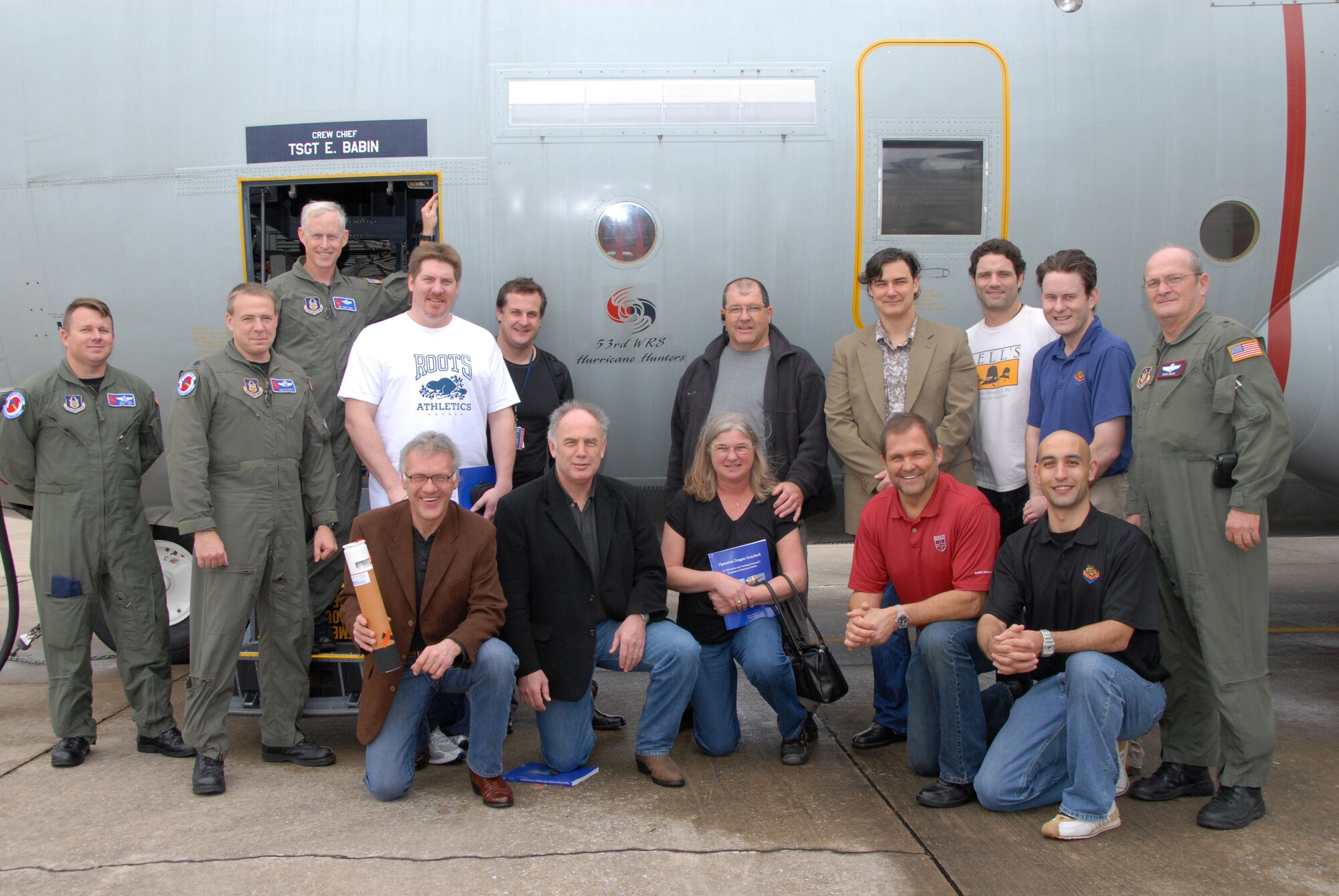 Aircrew from the 53rd Weather Reconnaissance Squadron join with a tour group of National Hockey League alumni and members of the the Mississippi Seawolves Foundation in a group photo next to a WC-130J. This aircraft is used by the Hurricane Hunters to gather information about storms with the potential to impact the U.S. and neighboring countries. The group spent time in a briefing learning about the Hurricane Hunter mission and took a tour of the aircraft. The alumni were in town for a charity event in support of the foundation.