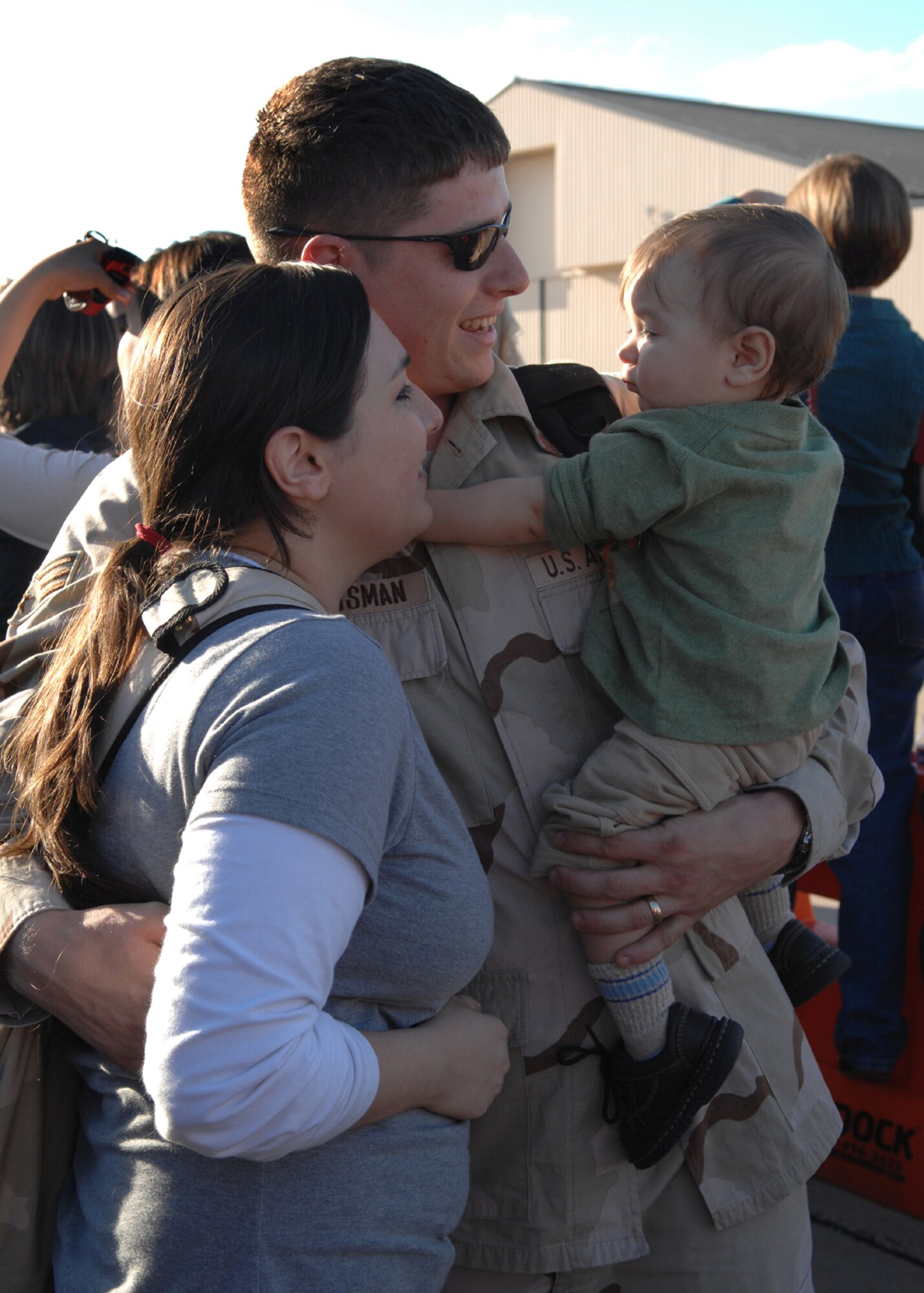 DYESS AIR FORCE BASE, Texas - Senior Airman Shaun Huntsman, from the 317th Airlift Group,  is greeted by his wife, Crystal, and son Shaun Jr. after a four month deployment to Southwest Asia. A group of more than 250 Airmen returned Feb. 19. (U.S. Air Force photo by Airman 1st Class Jennifer Romig)