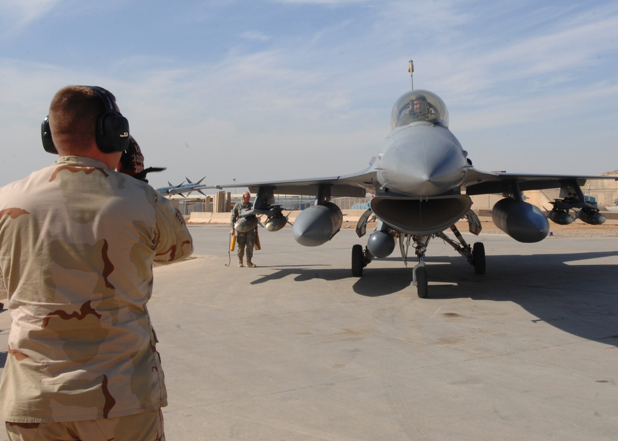 BALAD AIR BASE, Iraq -- Lt. Col. George Uribe, 332nd Expeditionary Operations Group fighter pilot, taxis into a hardened aircraft shelter after completing 1,000 combat flying hours as an F-16 Fighting Falcon pilot. Colonel Uribe is deployed from Tyndall Air Force Base, Fla. (U.S. Air Force photo/ Senior Airman Julianne Showalter)