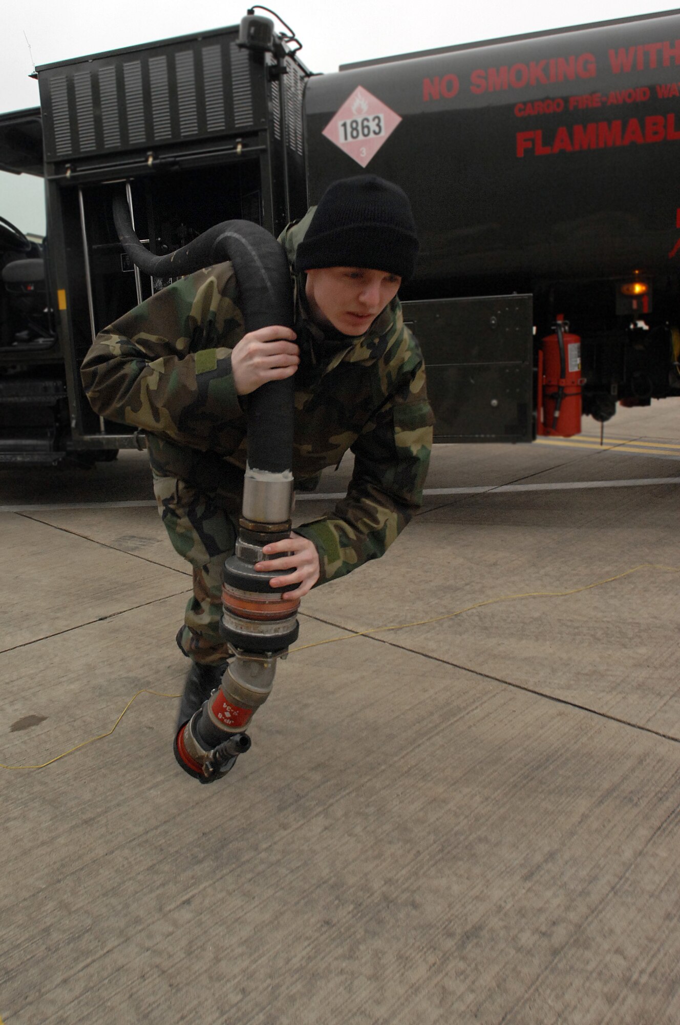 Airman 1st Class Shawn Carter, 100th Logistics Readiness Squadron Fuels Management Flight technician, drags a fuel line from an R-11 vehicle to a KC-135 Stratotanker at RAF Mildenhall.  Fuels management Airmen kept the lifeblood of airpower flowing by delivering more than 35 million gallons of JP-8 in fiscal 2007.  Airman Carter recently returned from a four-month deployment to Southwest Asia with the distinction of pumping the most fuel, more than 7 million gallons, at that location.  (U.S. Air Force by Senior Airman Teresa Hawkins)