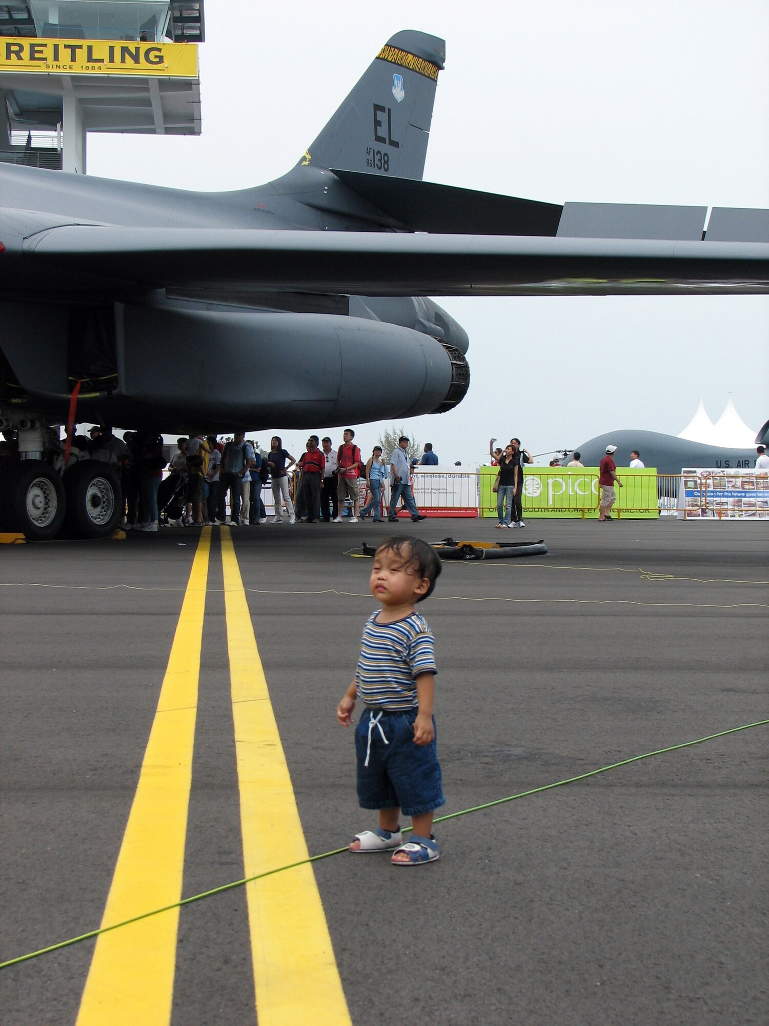Eighteen-month-old Aryandana Yudono explores the Department of Defense aircraft pavilion during a public day at the 2008 Singapore Air Show Feb. 23.  Born in Chicago, Aryandana was attending the air show with his parents who recently relocated to Singapore.  Seven U.S. military aircraft were on display at the air show including a B-1B bomber, F-15C, F-16CJ and F/A-18F fighters, a KC-135 tanker and WC-130J weather reconnaissance aircraft.  (U.S. Air Force Photo by Senior Master Sgt. Charles Ramey)