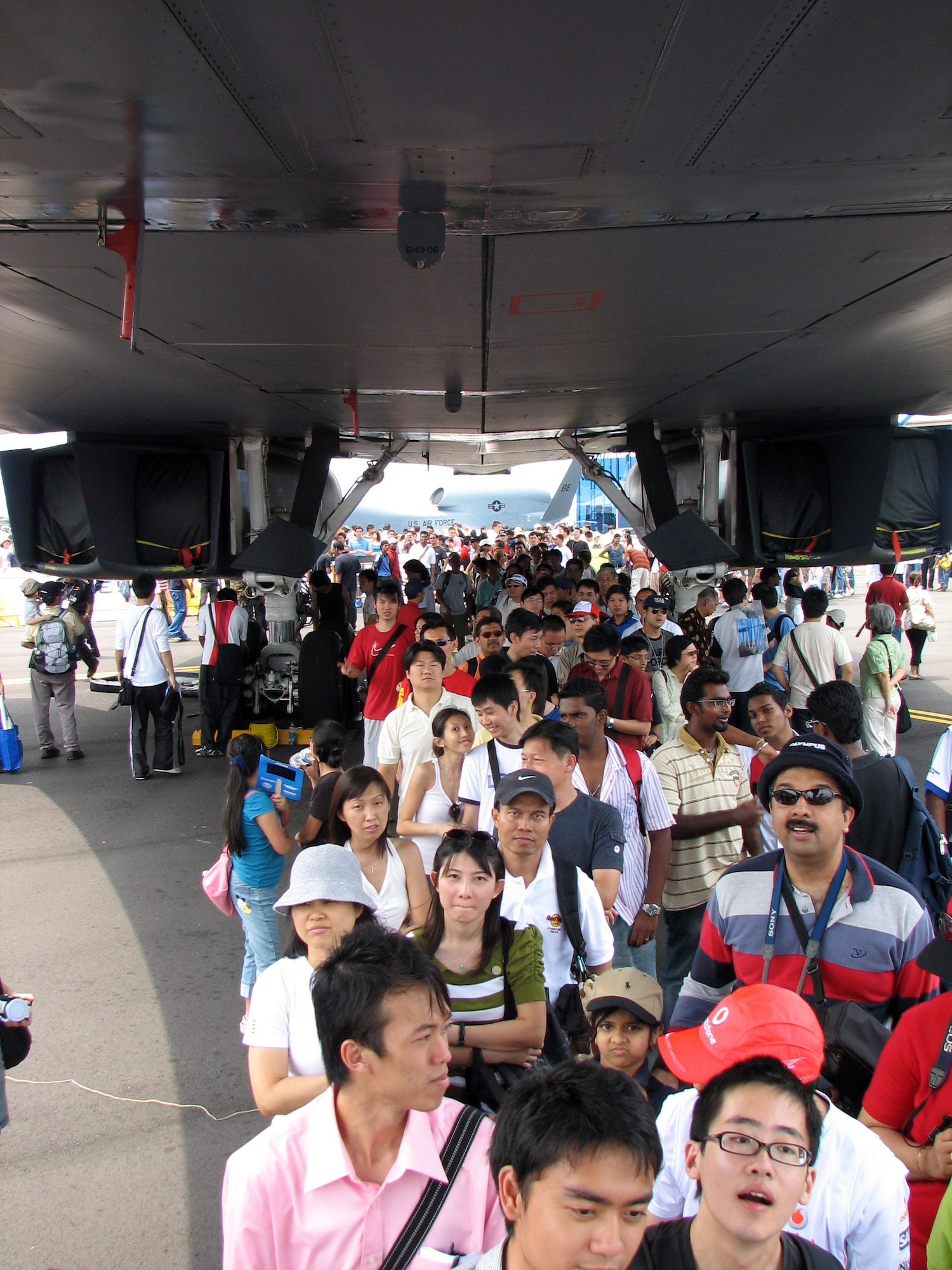 Spectators wait in line to peer inside the cockpit of a B-1B bomber during a public day at the 2008 Singapore Air Show Feb. 23.  The United States provided U.S. Air Force F-16CJ and U.S. Navy F/A-18 Super Hornet demonstations and seven aircraft for static display including a B-1B bomber, F-15C, F-16CJ and F/A-18F fighters, a KC-135 tanker and WC-130J weather reconnaissance aircraft.  (U.S. Air Force Photo by Senior Master Sgt. Charles Ramey)