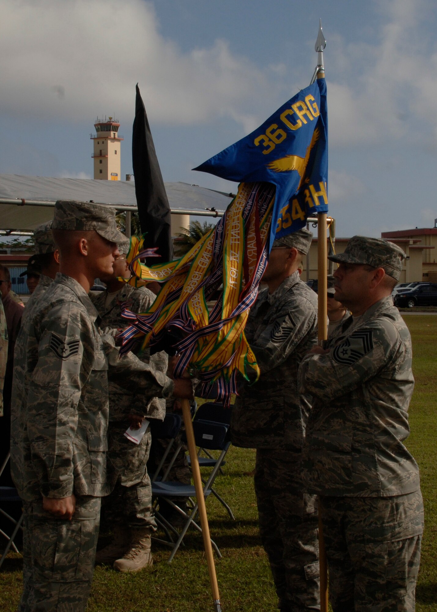 Members of the 36th Contingency Response Group present the new 554th RED HORSE Squadron flag during the squadron's relocation ceremony here Feb. 22. The 554th RHS moved to Andersen from Osan Air Base, Korea.  (U.S. Air Force photo/Airman 1st Class Zachary Hunter)
